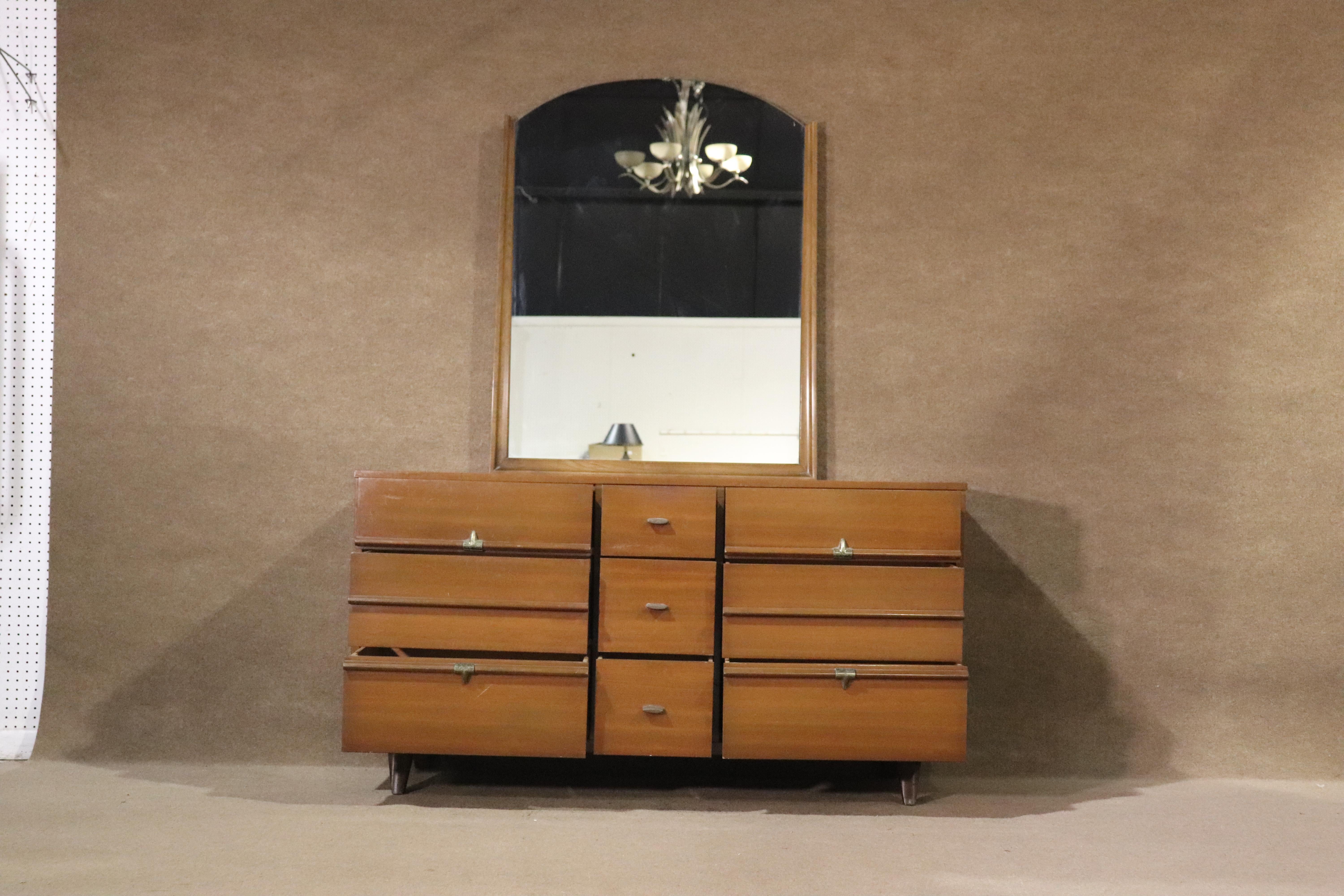 Long mid-century walnut dresser with wall mirror. Nine drawers with metal hardware.
Mirror: 55h, 33w
Please confirm location NY or NJ