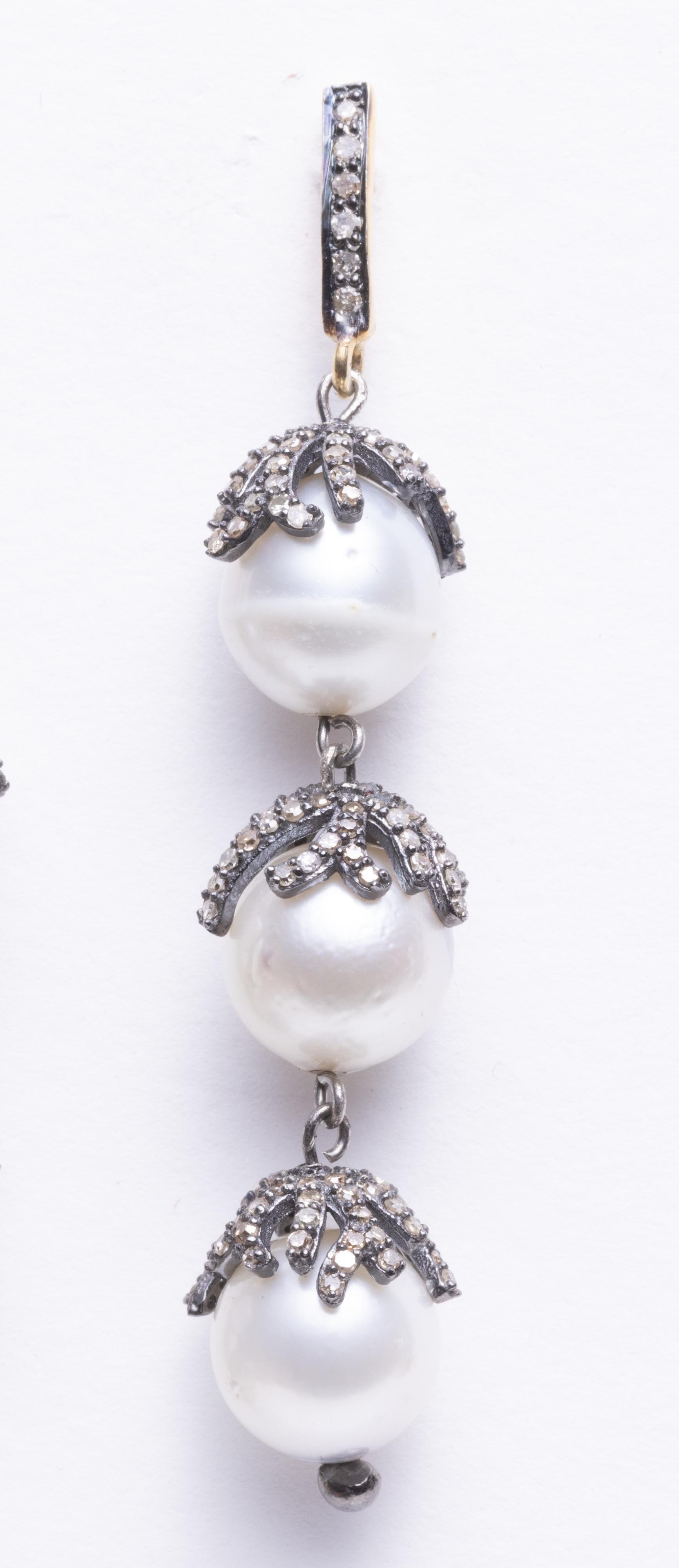 Three freshwater pearls with branch coral motif diamond rondelles.  Diamonds are round, brilliant cut in a pave` setting in an oxidized sterling silver.  18K gold post for pierced ears. 