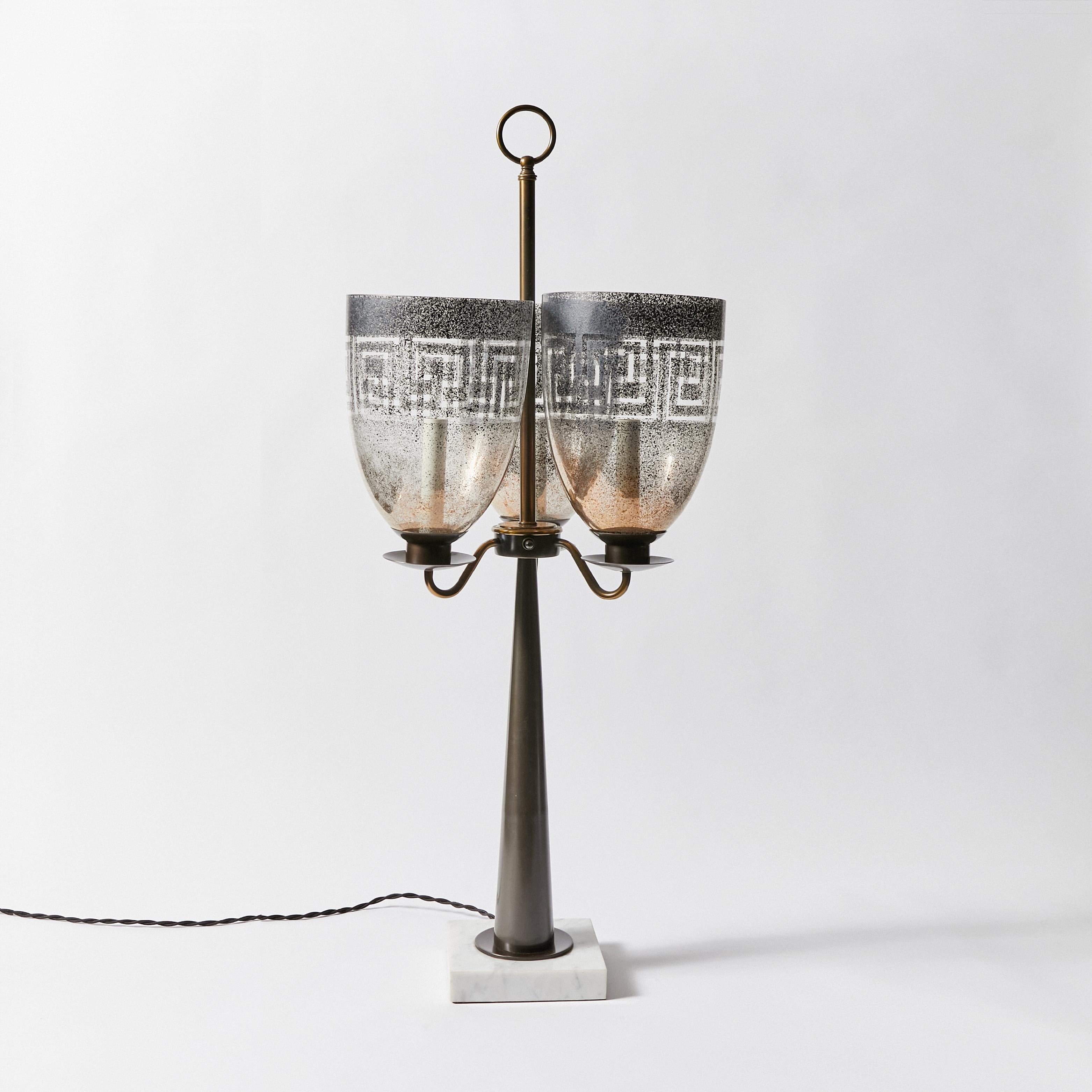 Triple hurricane shade candlestick table lamp in the manner of Tommi Parzinger. Made by Stiffel. This item has been refinished in Antique Bronze and rewired with braided cloth cord and new hardware. This lamp does not include shade or harp.