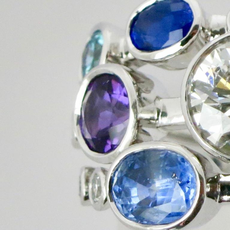 Triple gem set ring with 1 carat diamond and different coloured sapphires and aquamarine in 18 carat white gold. Please note this item is made to order and a similar but not identical piece can be made. Allow four weeks to delivery. 

Esther Eyre