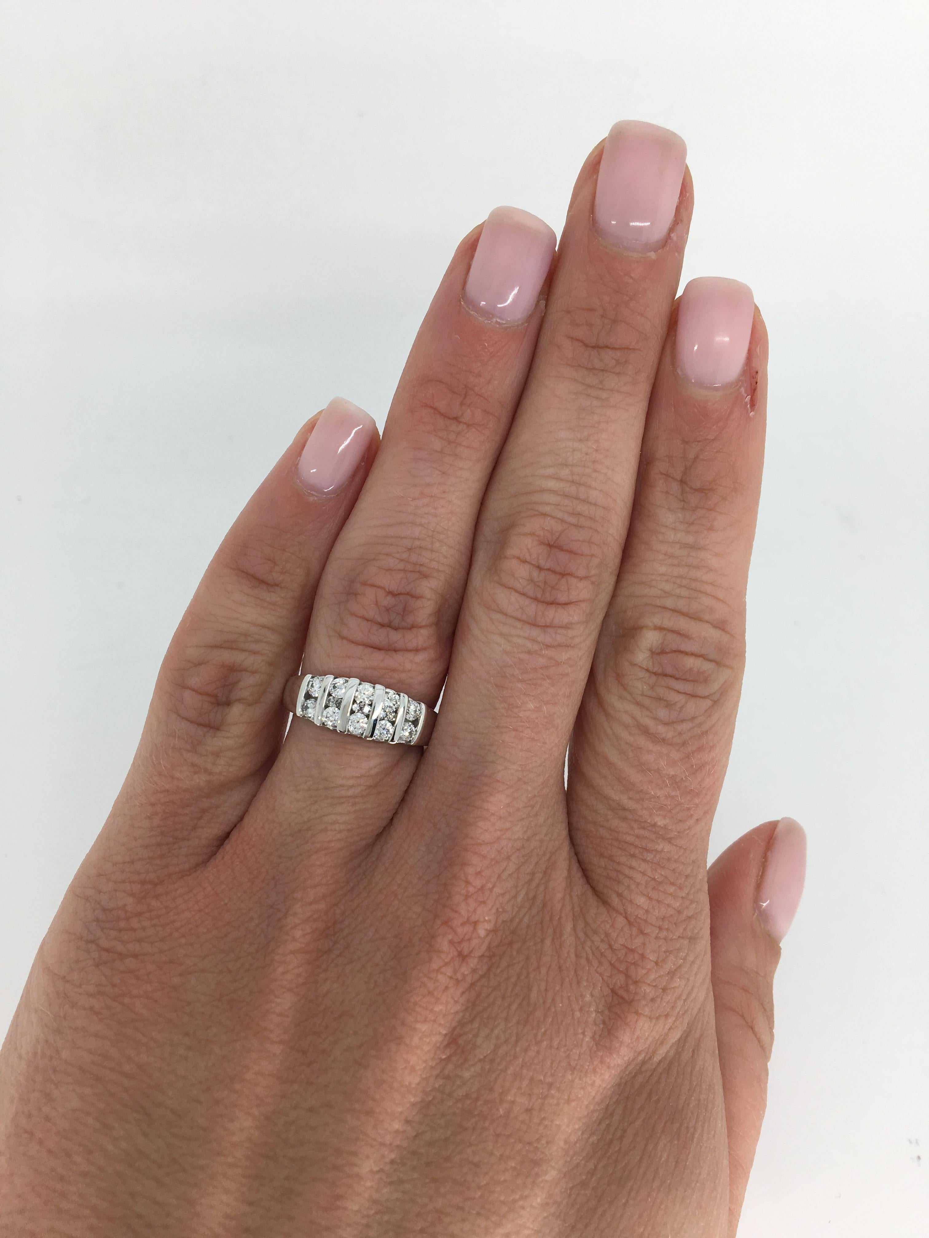 This stunning diamond band features .60CTW of diamonds set in two rows with 6 additional round brilliant cut diamonds hidden within the two rows set in 14K white gold.

Diamond Carat Weight: Approximately .60CTW
Diamond Cut: 16 Round Brilliant Cut