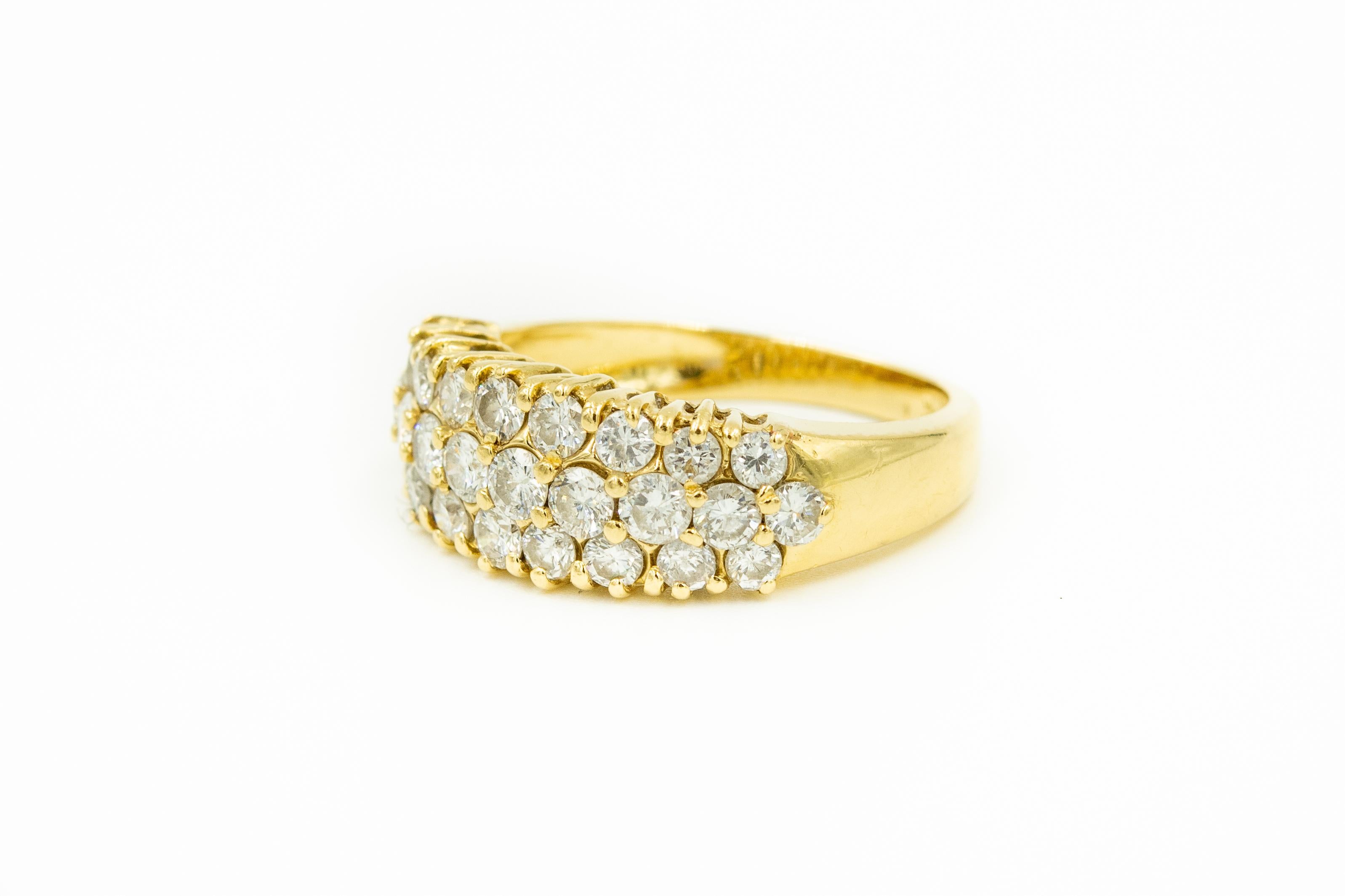 Simple elegance triple or three row diamond band ring made of 18k yellow gold ring containing 28 clean nice round brilliant diamonds with an approximate total weight of 1.40 carats.   The diamonds are only in the front which makes it easier to size