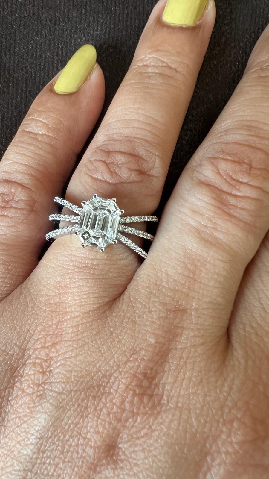 This ring is made in 18kt white gold with triple split shank splitting from the top & spreading like wings & connecting precisely towards the bottom.

Shank are half way studded with diamonds to give you a proper diamond look from the top.

The