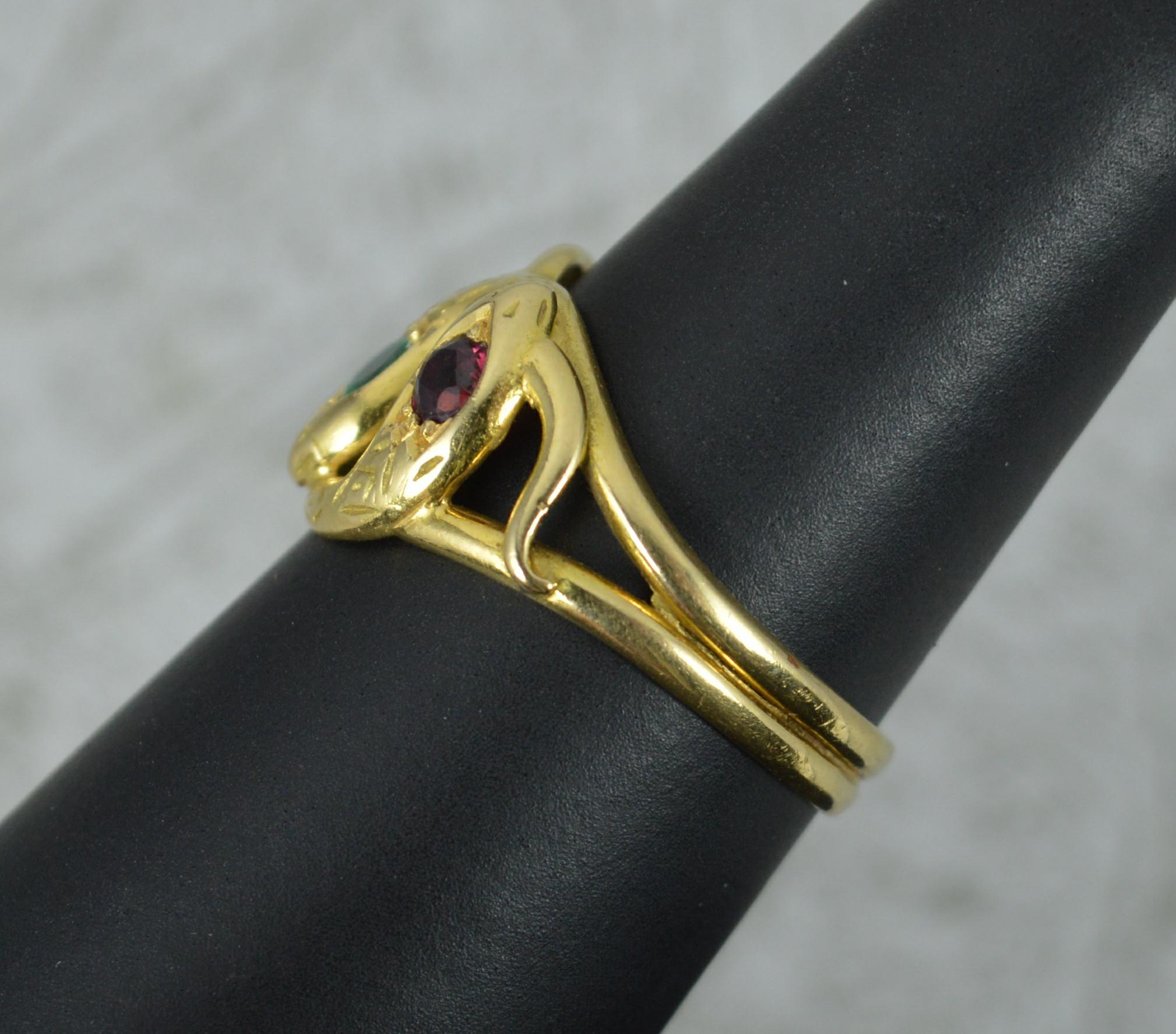 An impressive three snake design ring. Made from solid 18 carat yellow gold. The three snake heads each set with a different gemstone. 17mm x 12mm head.

Condition ; Very good. Strong, round band. Well set stones. Issue free.

Please view