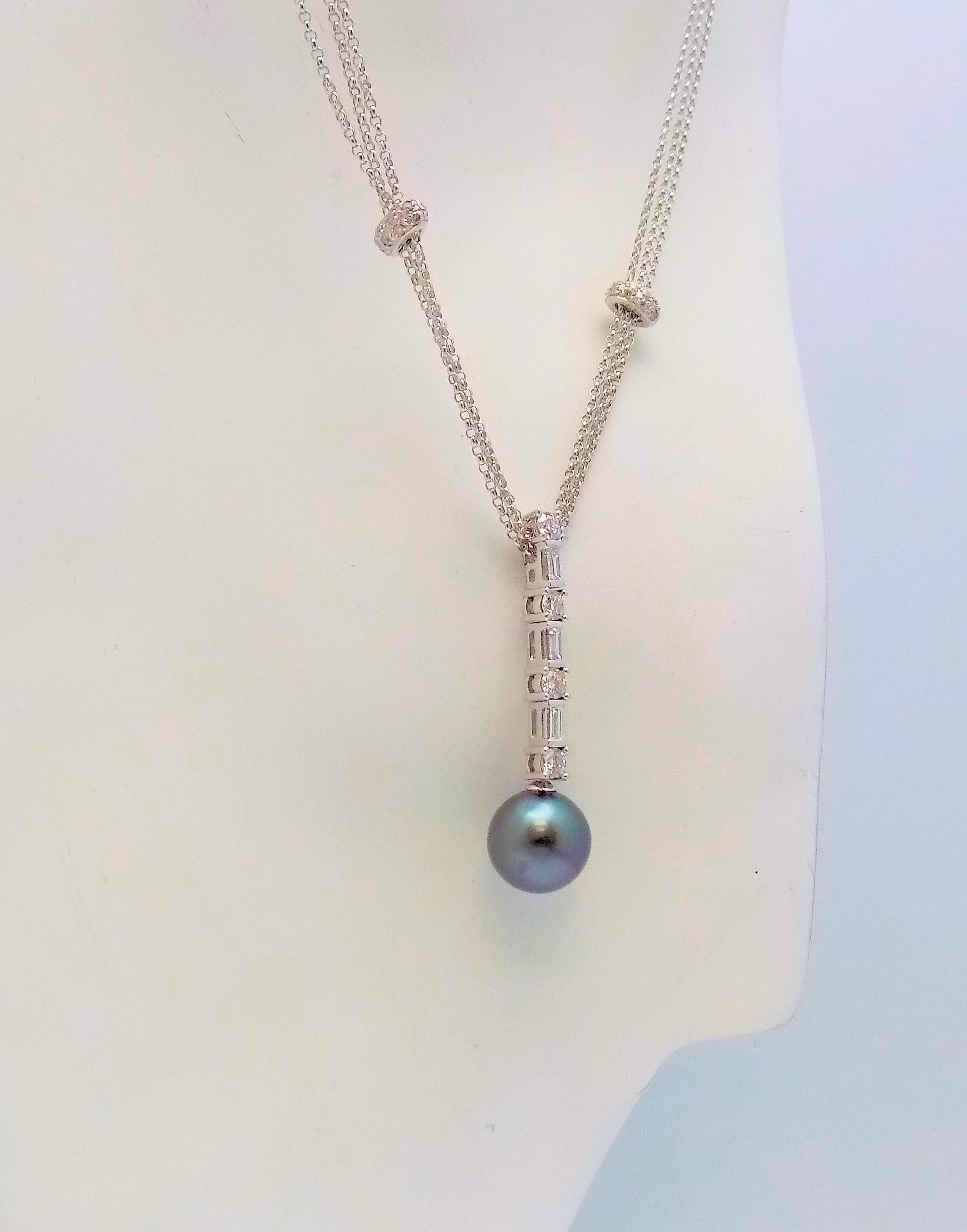 Gorgeous 14 Karat White Gold Triple Strand Necklace featuring (1) 10 MM Round Tahitian Cultured Pearl, 4 Round Brilliant Diamonds, 3 Baguette Cut Diamonds 0.62 Carat Total Weight, VS-SI, G-H; on 18