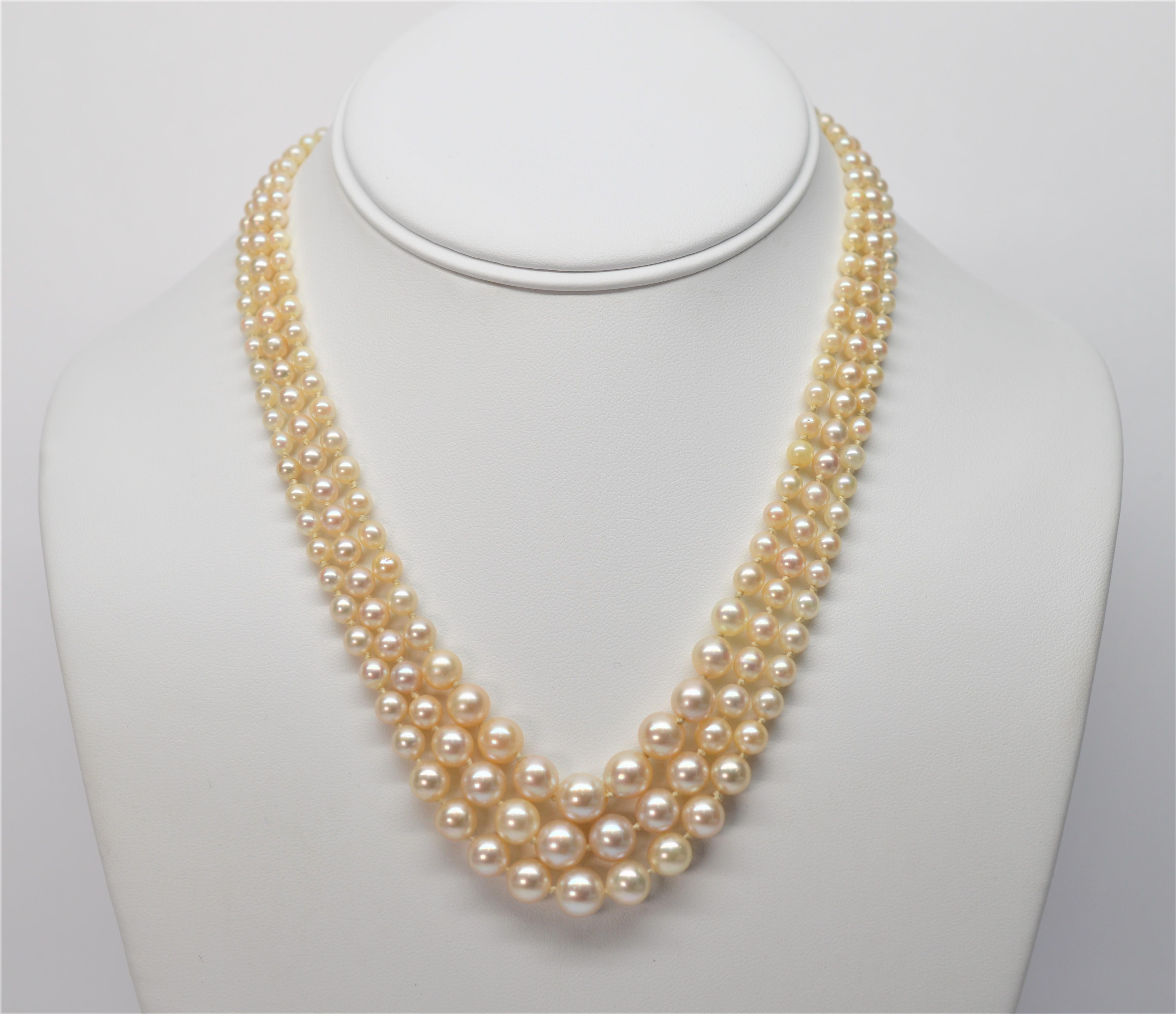 Three graduated strands of fine white lustrous Natural AA Akoya Pearls create this stunning quality Necklace. The hand-strung Pearls range in size from 3.5 mm to 8.25mm. The Pearls are dressed with a beautiful charm clasp made of 14K Yellow Gold &