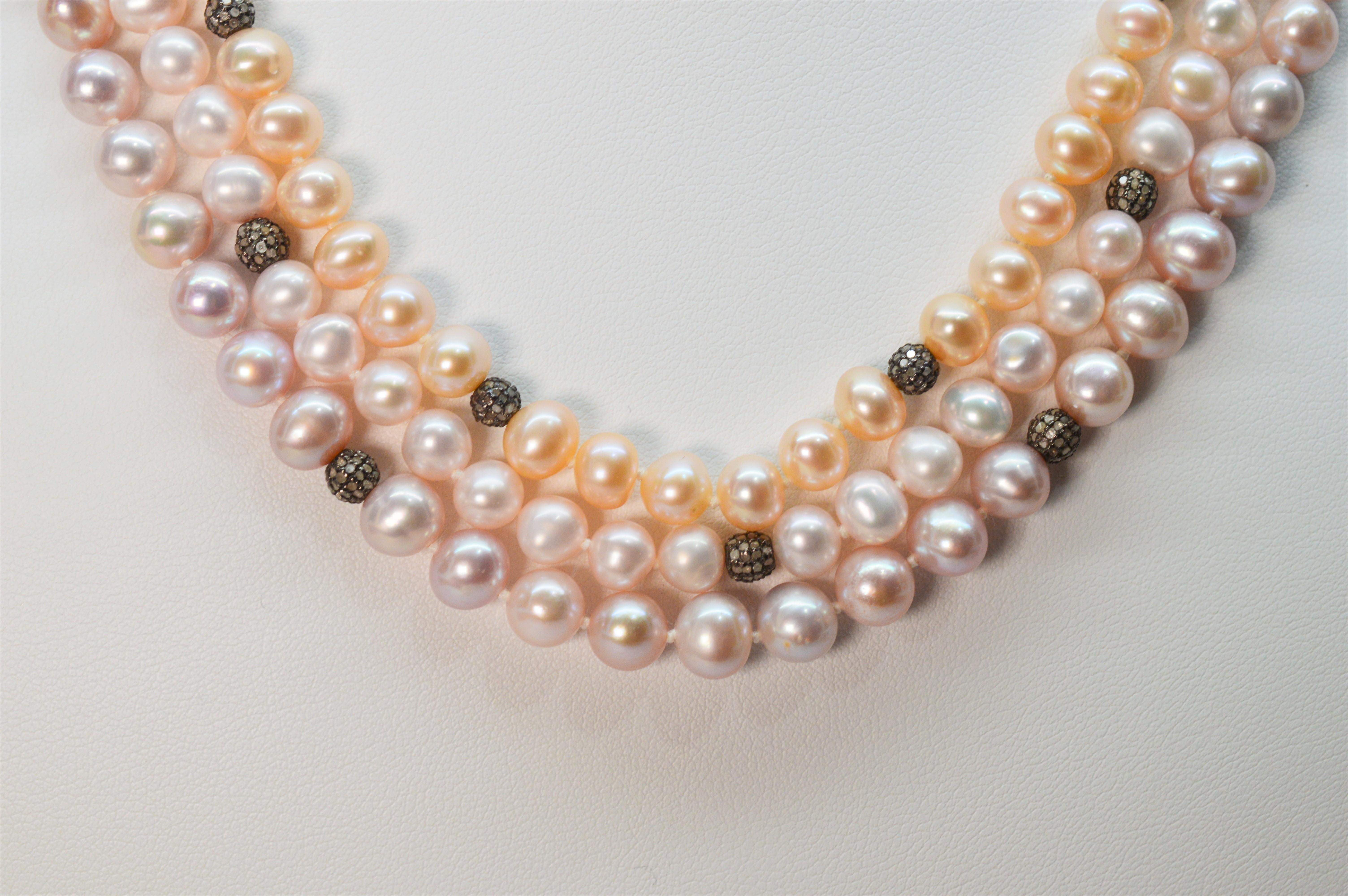 Various hues of light blush colors complement each other and mingle together to create this unique pastel Akoya pearl multi strand necklace. Each pearl strand is accented with tiny decorative diamond enhanced sterling silver bead stations that