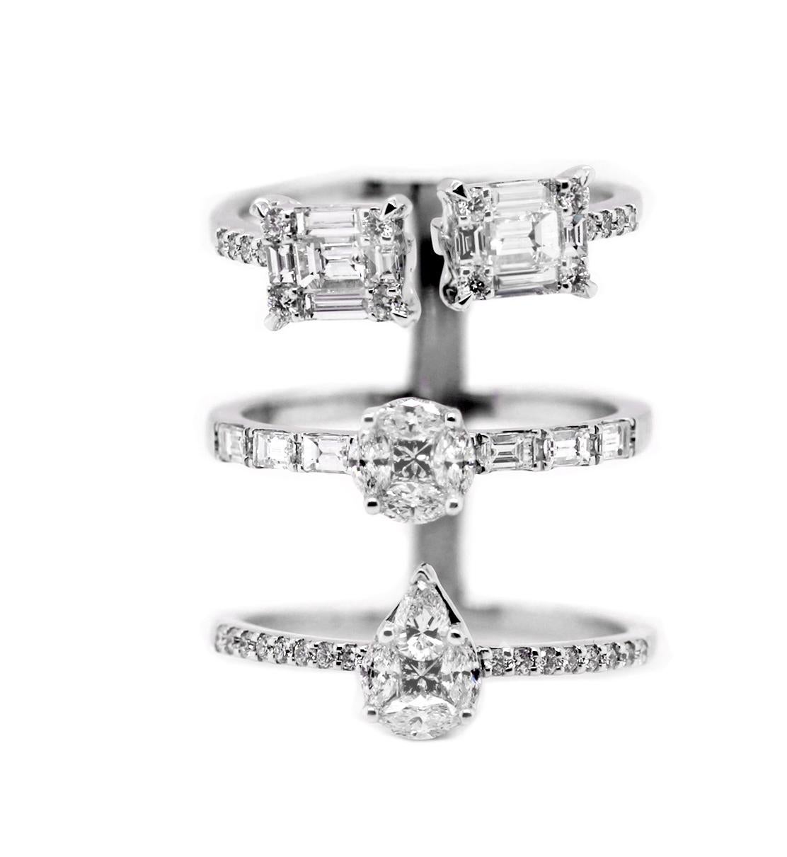 A one-piece three layer stacking-style ring featuring pearshape, round and rectangular clusters comprising marquise, pearshape, princess cut, baguette and round cut diamonds cleverly positioned to look like one larger stone at each tier.  With