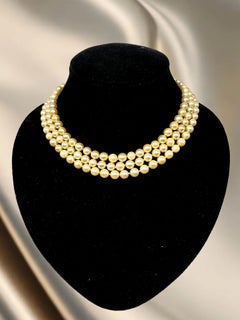 Triple-strand graduated pearl necklace with 14k yellow gold clasp and diamonds.