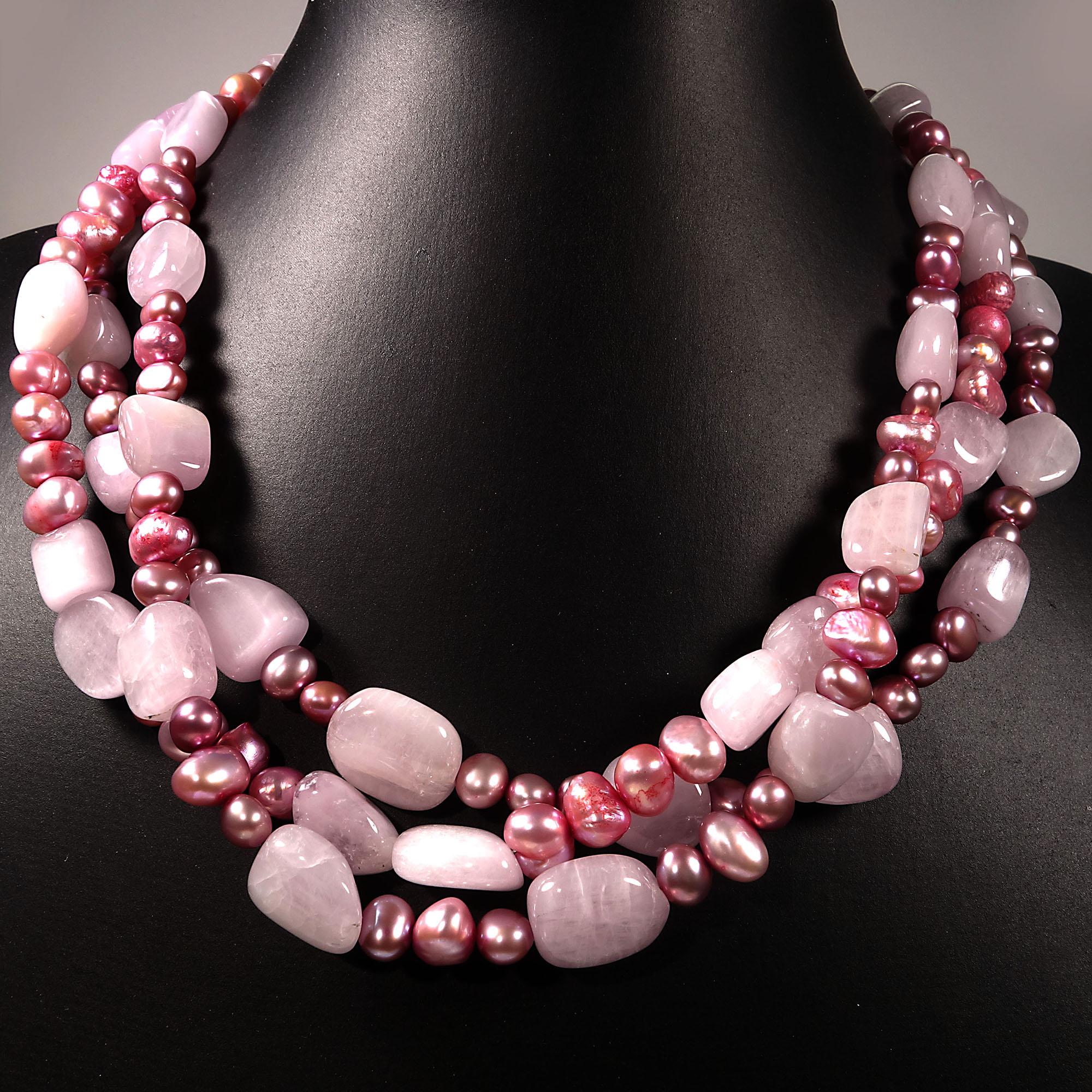 Elegant, handmade three strand necklace of highly polished pink Kunzite nuggets and pink pearls.  Each strand is designed differently. This unique 17 inch necklace is secured with a large white baroque pearl with sterling silver hooks.  The pearls