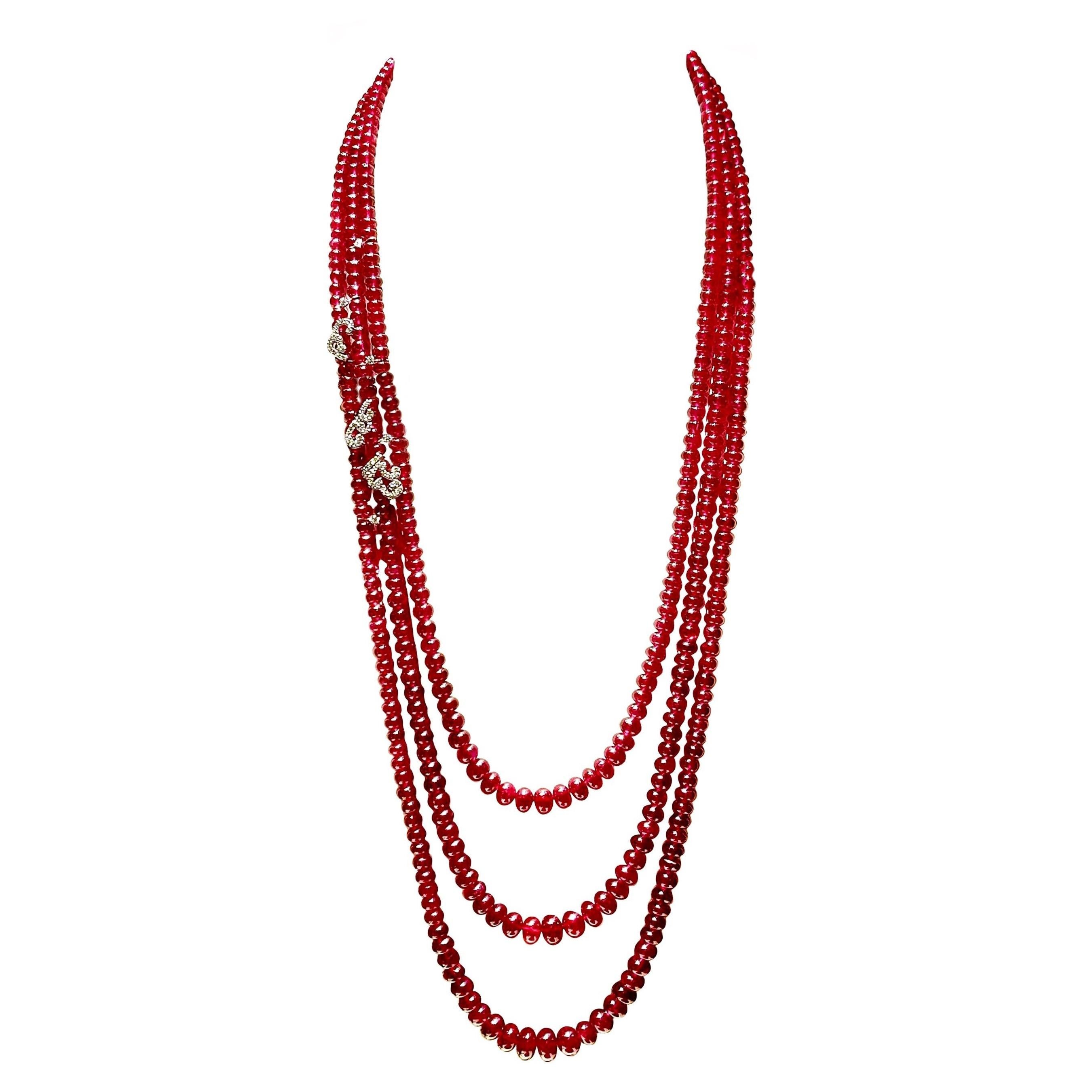 ---------------------------------------
         BESPOKE PIECE
---------------------------------------

Triple Strand Ruby Bead Necklace with Scattering Diamond 18K White Gold Curled Petals and Pollens

Gold: 18K White Gold, approx. 9 g
Diamond: