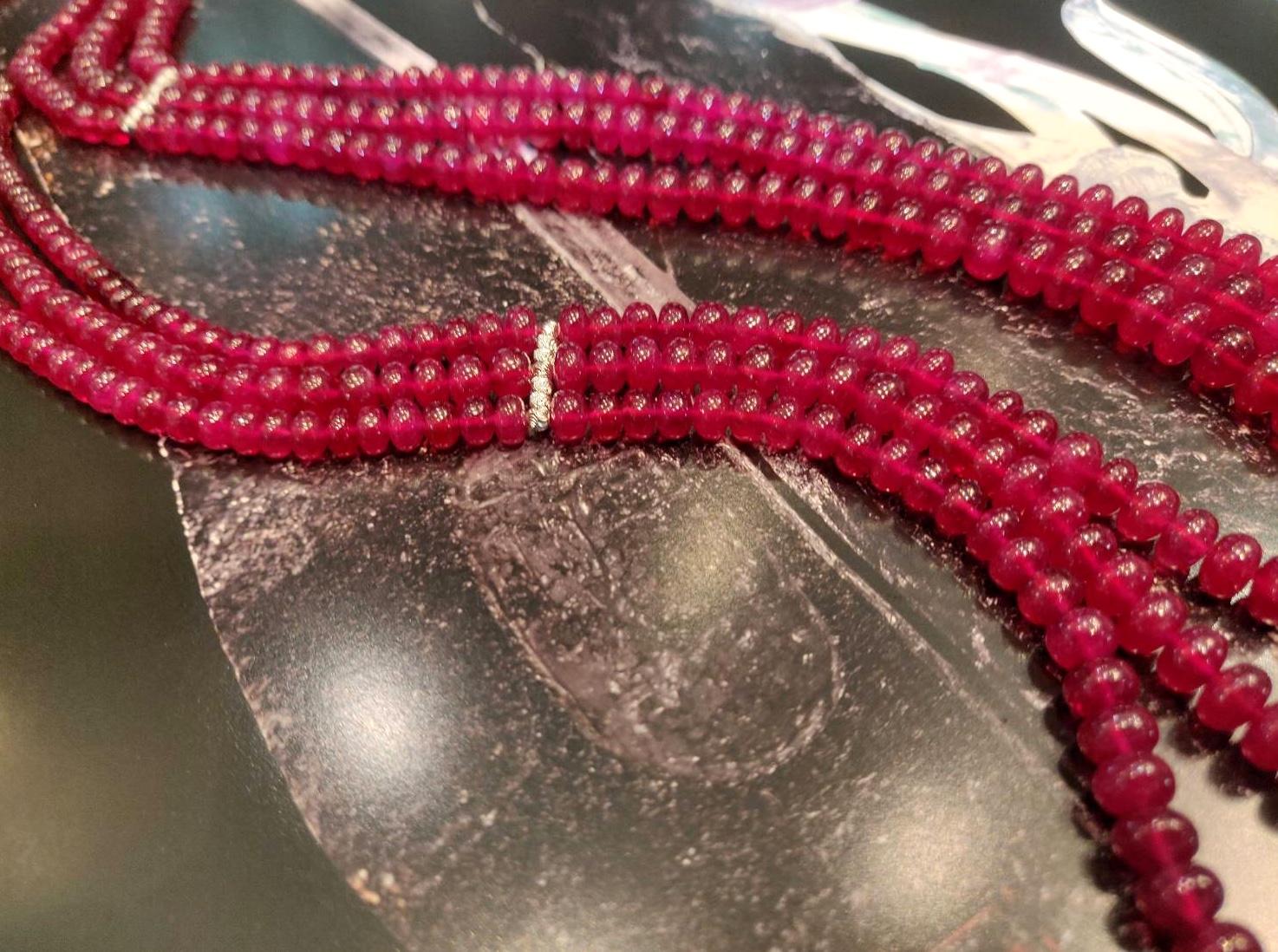 ---------------------------------------
         BESPOKE PIECE
---------------------------------------

Triple Strand Ruby Bead Necklace with Faceted Diamond Cut White Gold Bar Spacers

Gold: 18K White Gold, approx. 1.5 g
Ruby: Cabochon Bead,