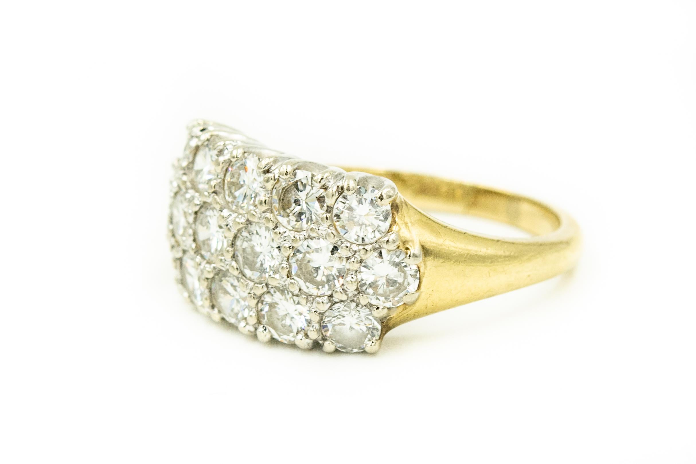 Nicely made diamond ring containing  3 rows of diamonds -  16 stones weighting approximately .15 carats each for an approximate total weight of 2.40 carats.  The stones are set in 14k white gold and the rest of the band is 14k yellow gold.

It is a