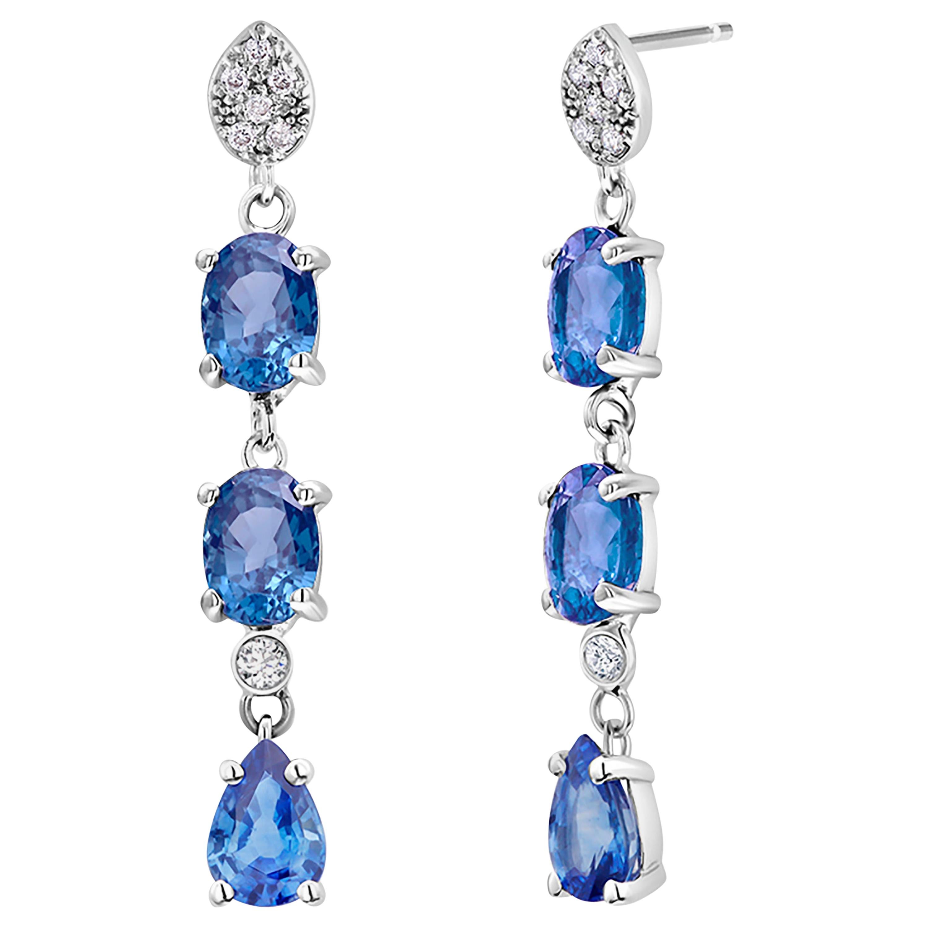 Fourteen karats white gold drop earrings two-inch long
Diamonds weighing 0.30 carat 
Four oval and two pear shape vibrant, vivid, and brilliant Ceylon sapphires weighing 3.30 carat
Sapphire hue color: cornflower blue
One of a kind earrings
New