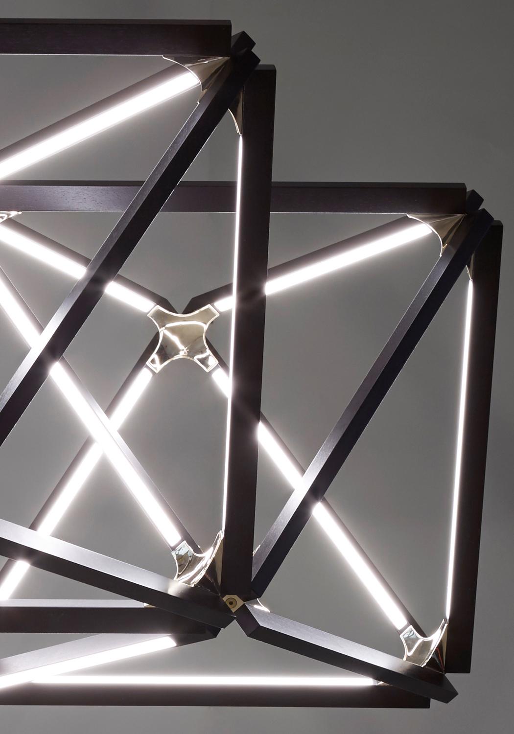 The triple X chandelier by Stickbulb was designed by Rux in 2015 and is made in New York City, USA.

The X collection transcends the line between lighting and furniture. It includes illuminated pieces that can function as tables, chandeliers, or
