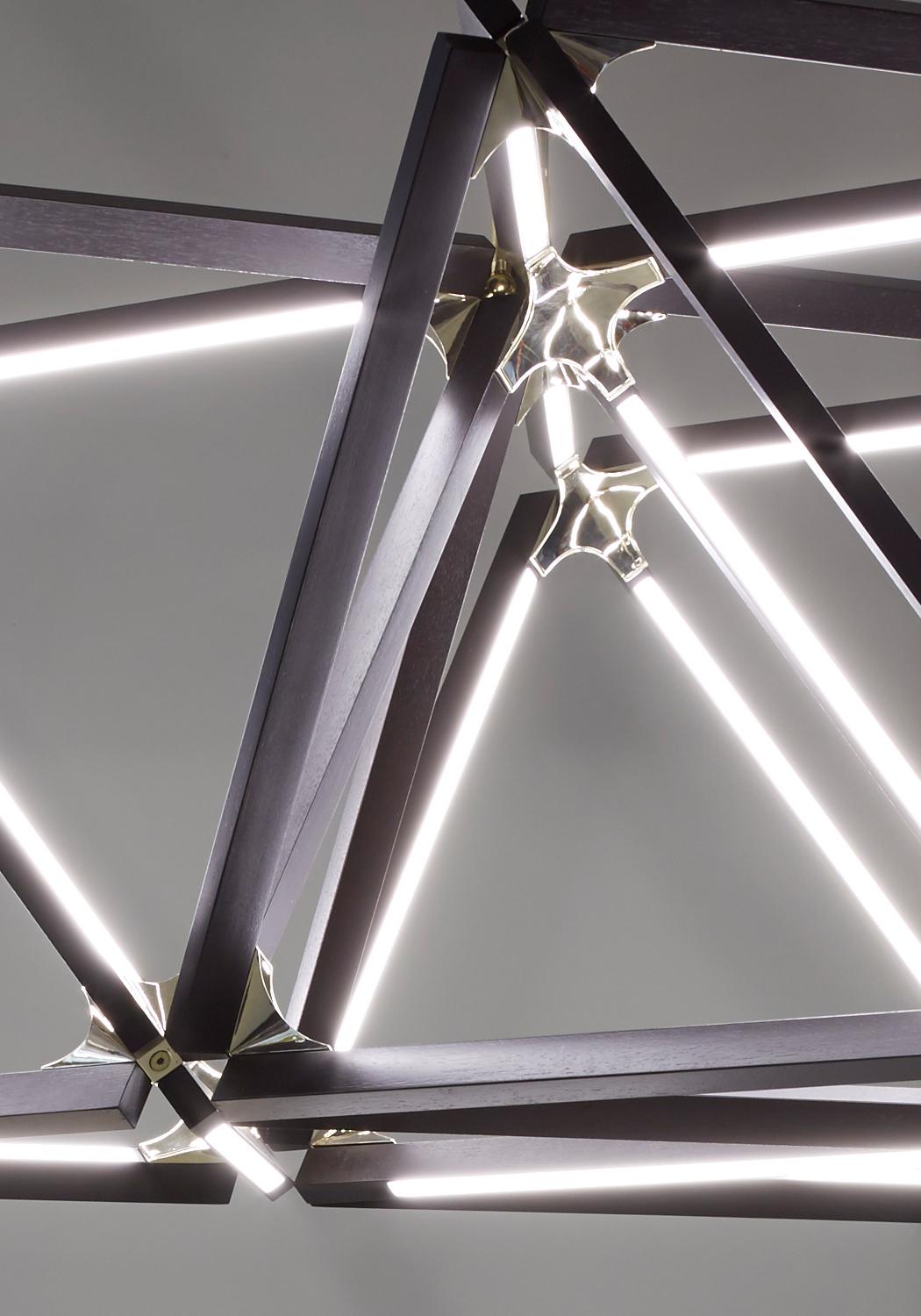 Modern Triple X Chandelier Ebonized Oak Brushed Brass For Sale