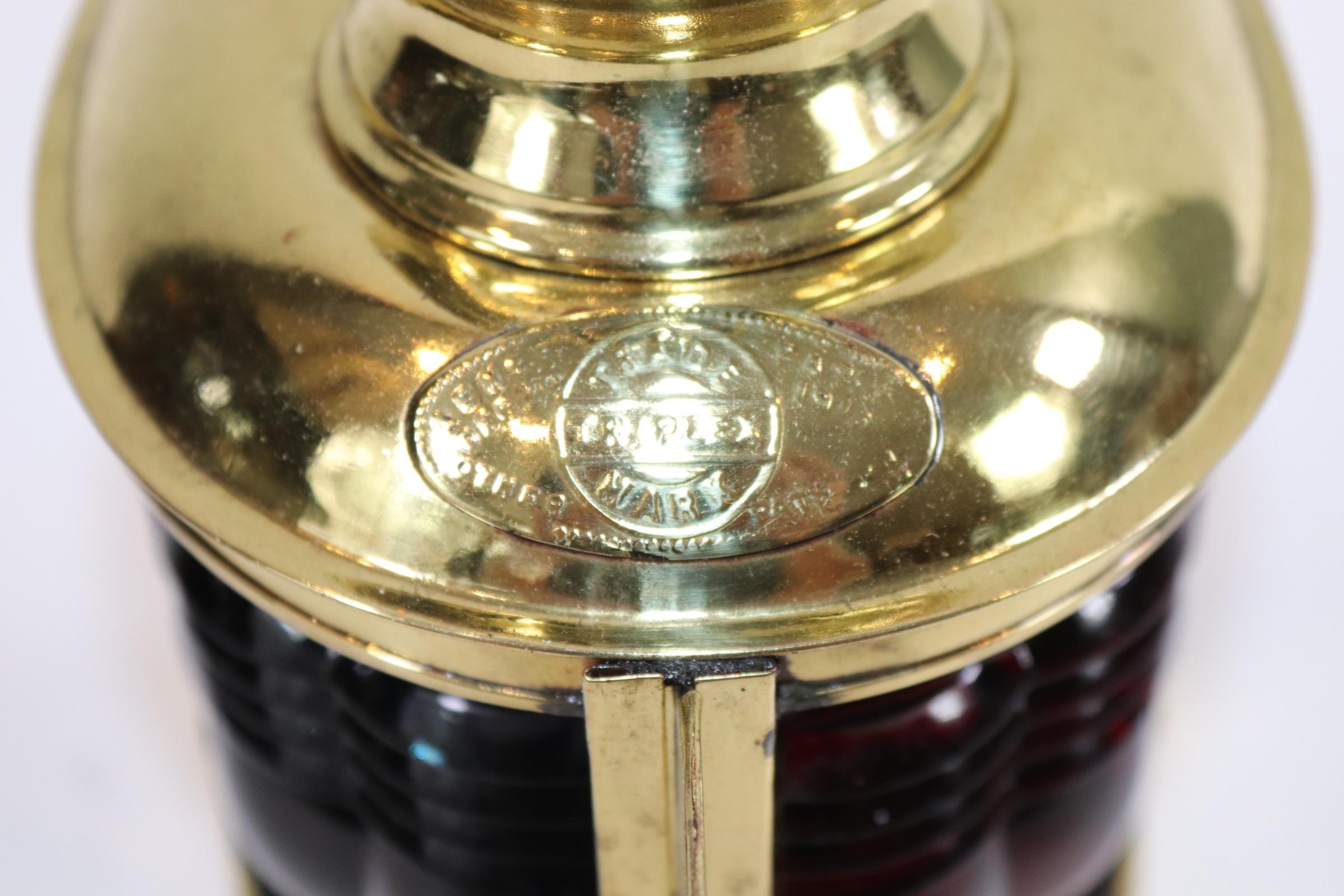 Brass bow boat lantern by Triplex. With red and green Fresnel glass lenses and a patent date of April 1st 1913. Fitted with its original burner. Weight is 2 pounds.