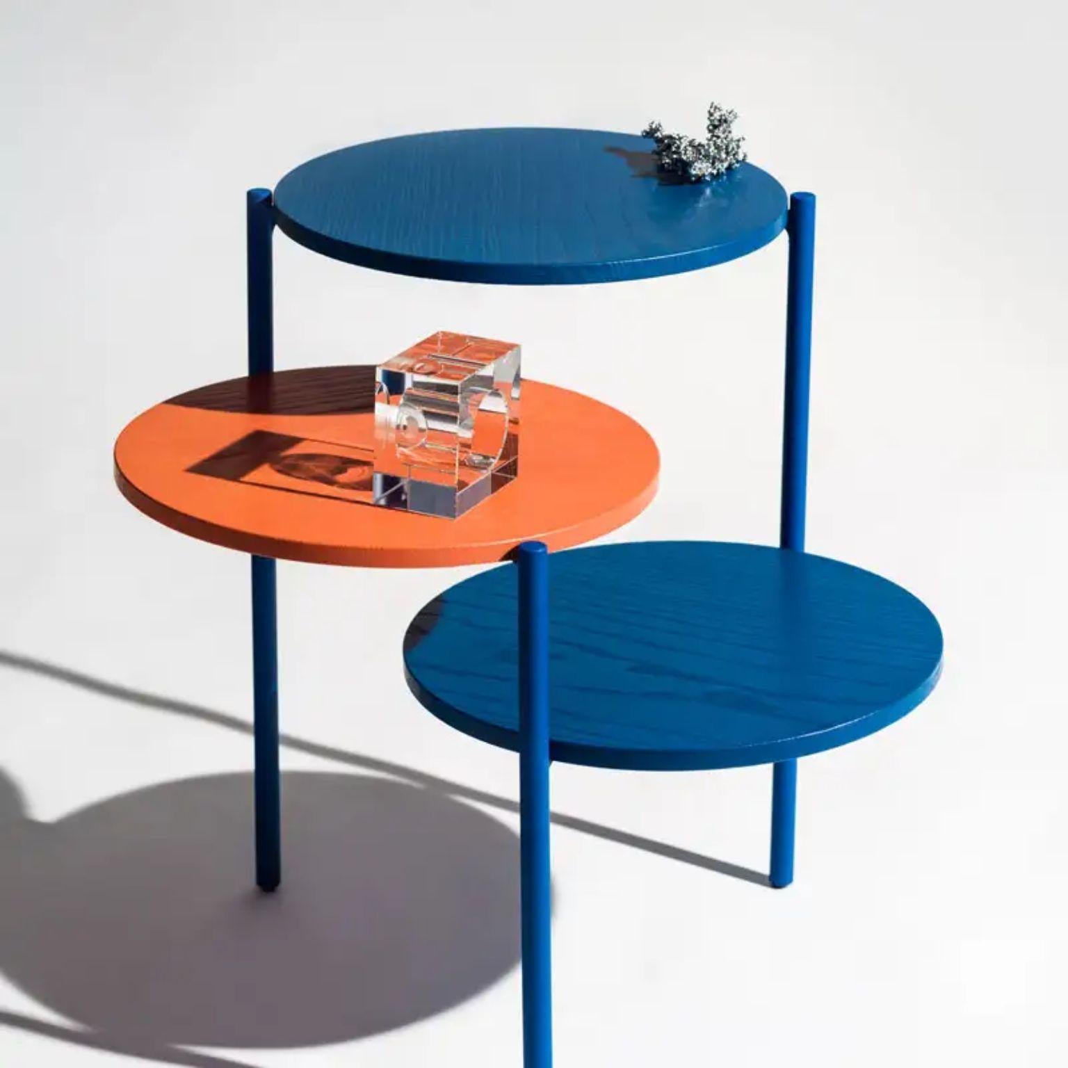Triplo orange and blue coffee table by Mason Editions
Designed by Martina Bartoli.
Dimensions: Ø 54 cm x H 52.5 cm.
Materials: Ash solid wood and metal.

Available in different colors and finishes.

A design based on the concept of dissecting