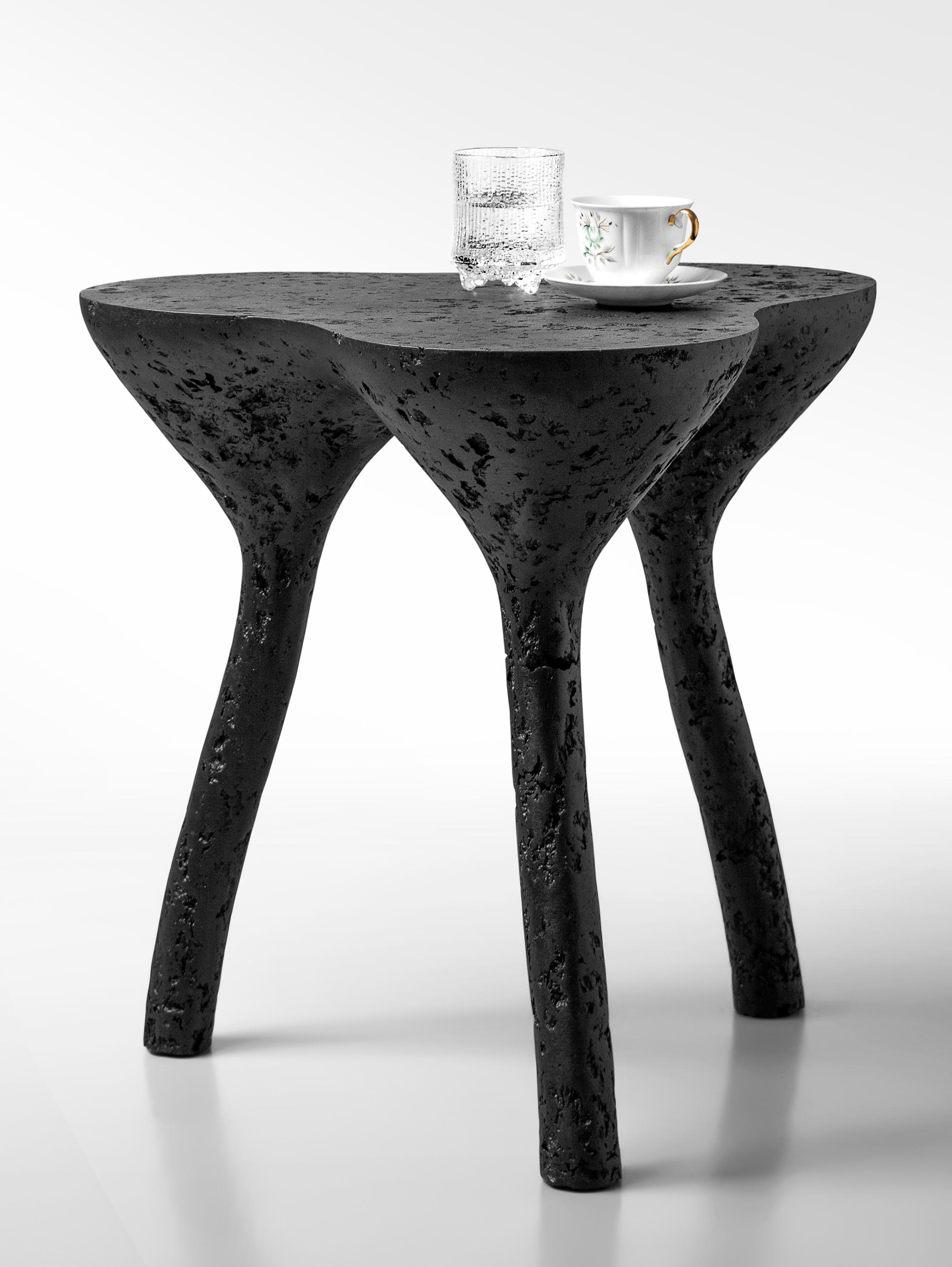 Tripod Black Coffee Table by Donatas Zukauskas
Dimensions: Ø 50 x H 52 cm.
Materials: Concrete, wood, recycled paper, glue, and paint.

The fusion of sturdiness and elegance, along with the blend of archaism
and modernity. More than just a surface