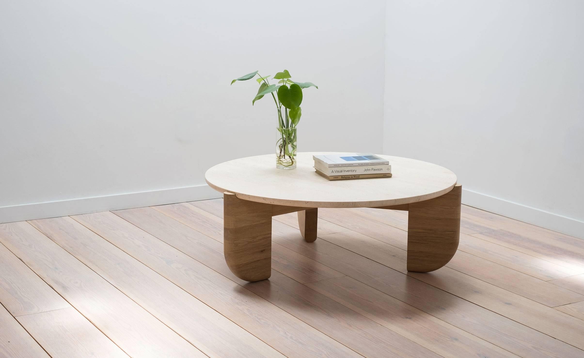 The Tripod Coffee Table is an exploration of material, texture, and form. The base and top were designed to fit together as one, with the bottom curve of the stone seated neatly in the inverse curve of the wooden legs. This piece is made by hand in