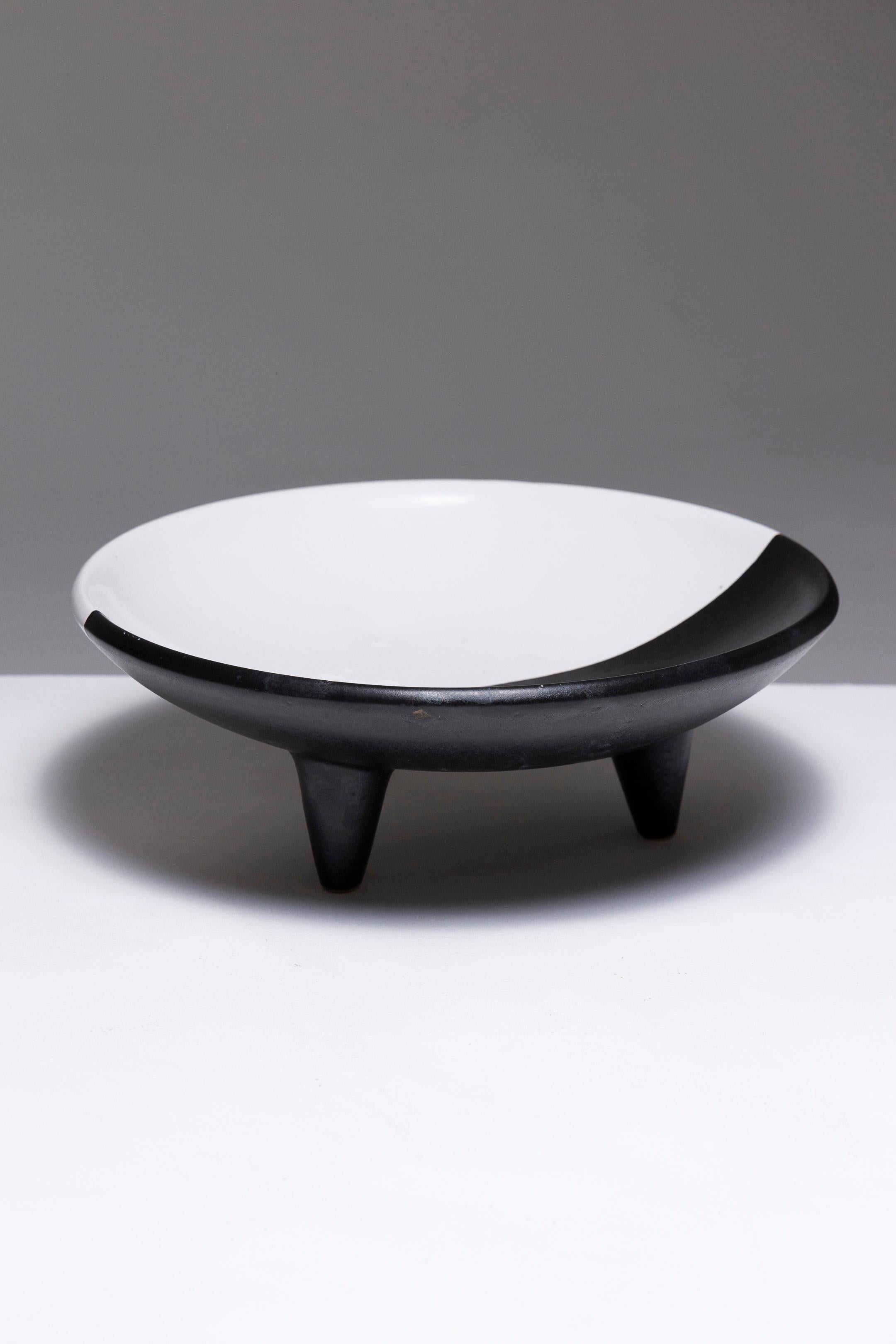Large Tripod Earthenware Bowl, Vallauris, 1970s. Circular in shape, resting on three legs. Decorated in the style of 'Demi' pieces, with two colored glazes: metallic black and white. Reflecting long-standing Mediterranean exchanges between North