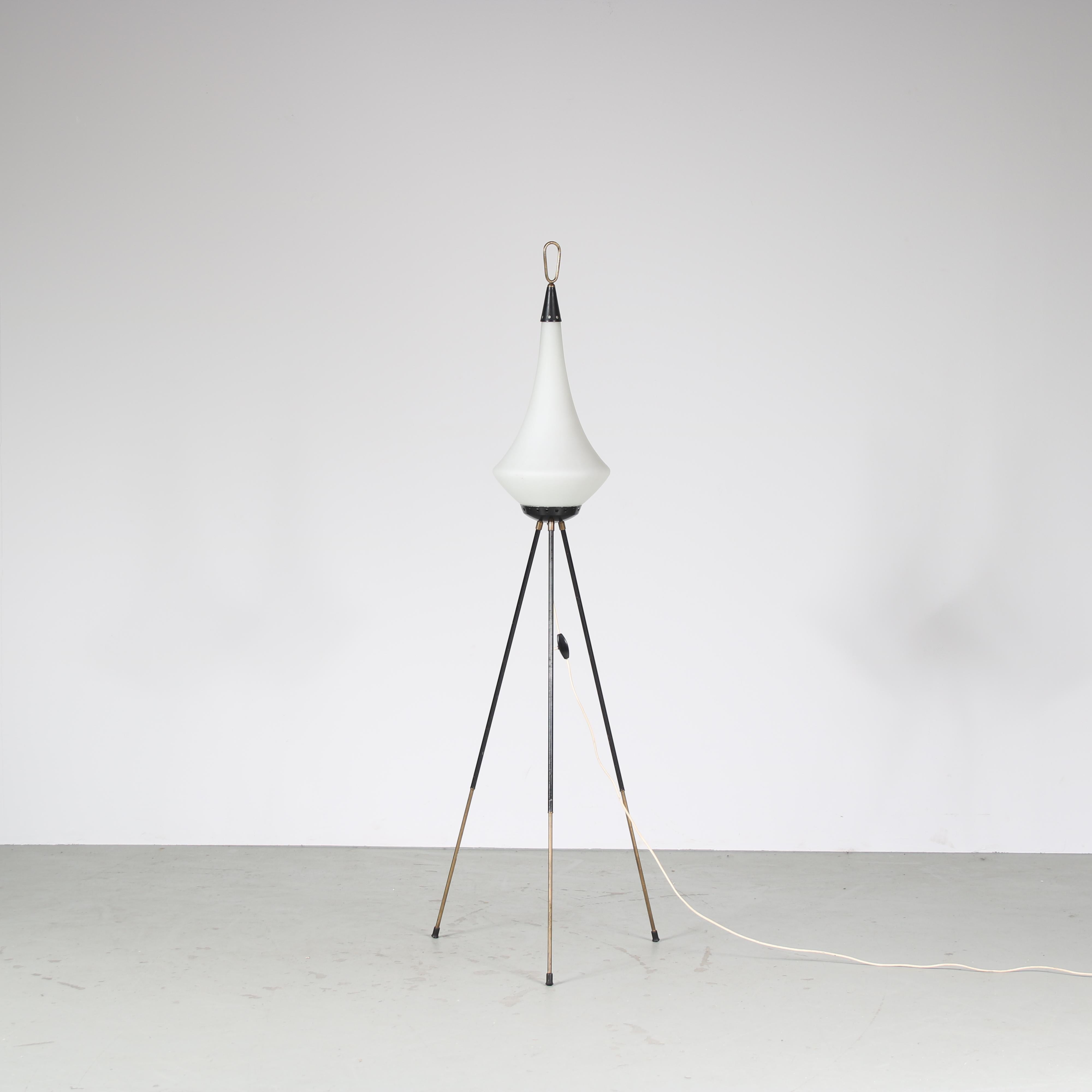 A fantastic floor lamp manufactured by Stilnovo in Italy around 1950.

Made of high quality black lacquered metal with brass details. The elegant tripod shape of the tubular base gives it a most luxurious appeal, nicely complimented by the milk