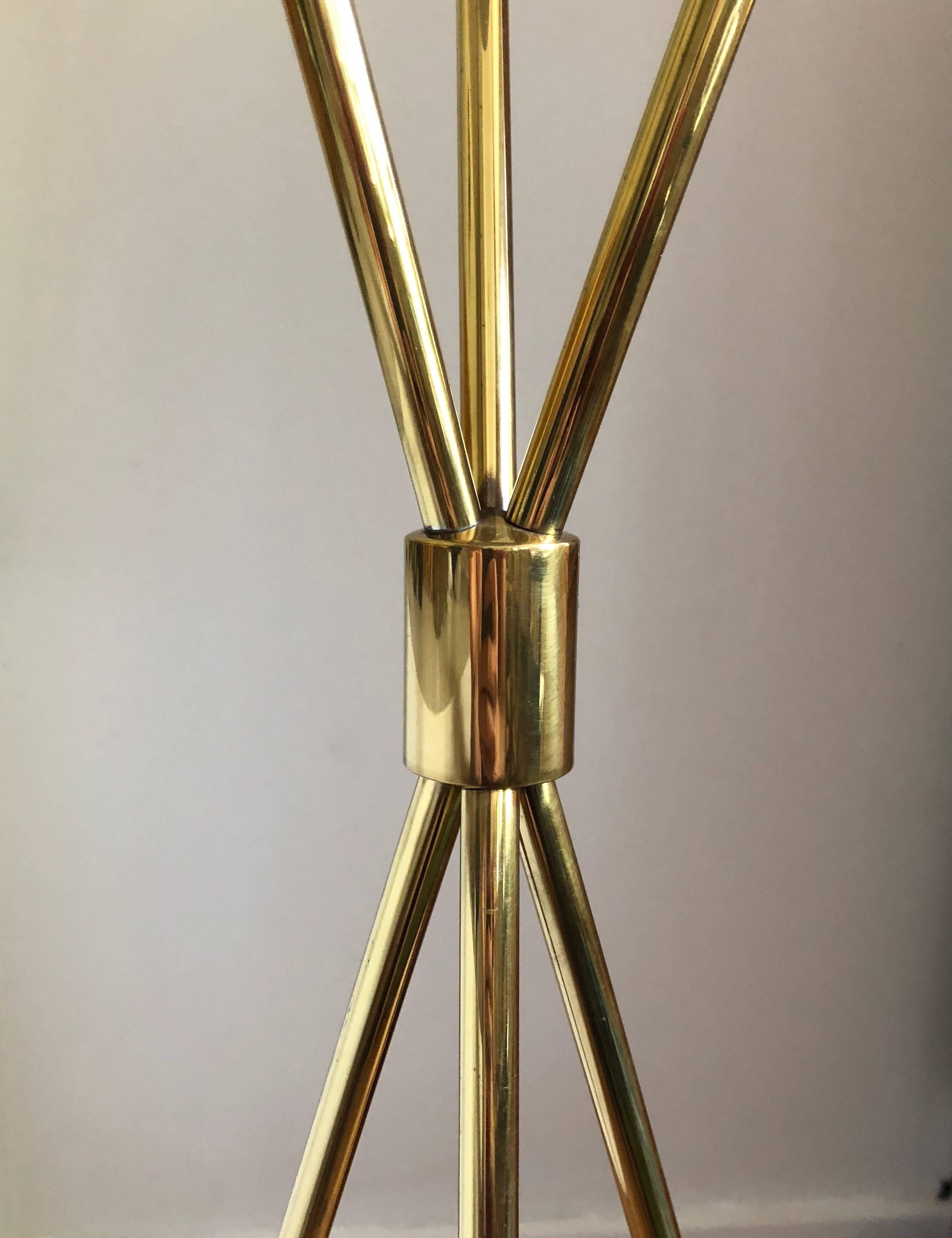 Solid brass tripod floor lamp model 206, first introduced in 1950. This example is likely from the early 1970s and retains a clean, tarnish-free high-polish brass finish with a light golden patina.