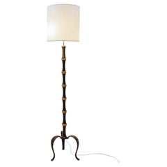 Tripod floor lamp in wrought iron and brass with a bamboo-style stem