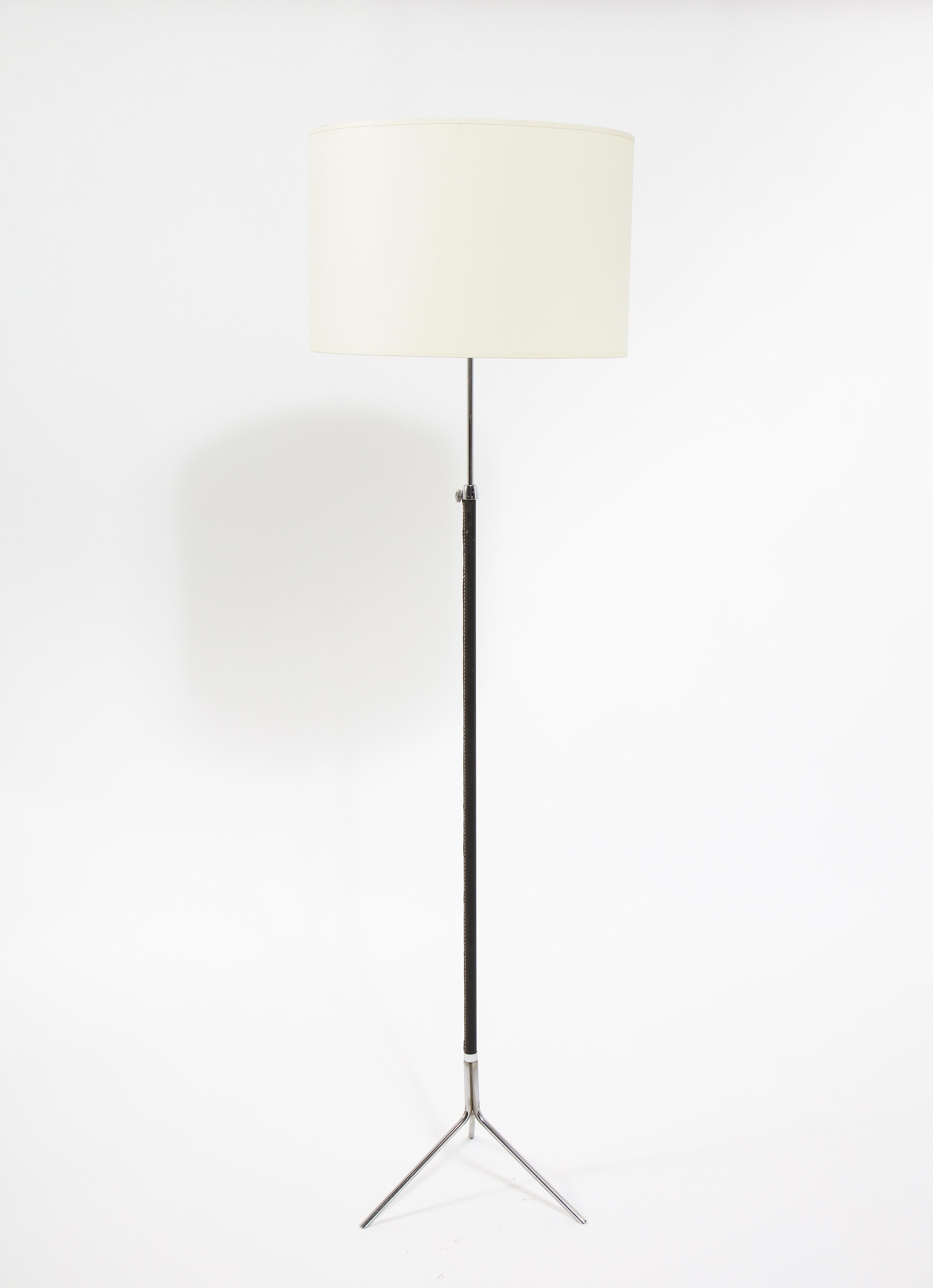 Elegant nickel-plated brass and leather standing lamp with adjustable height. Shade is for photographic purposes.