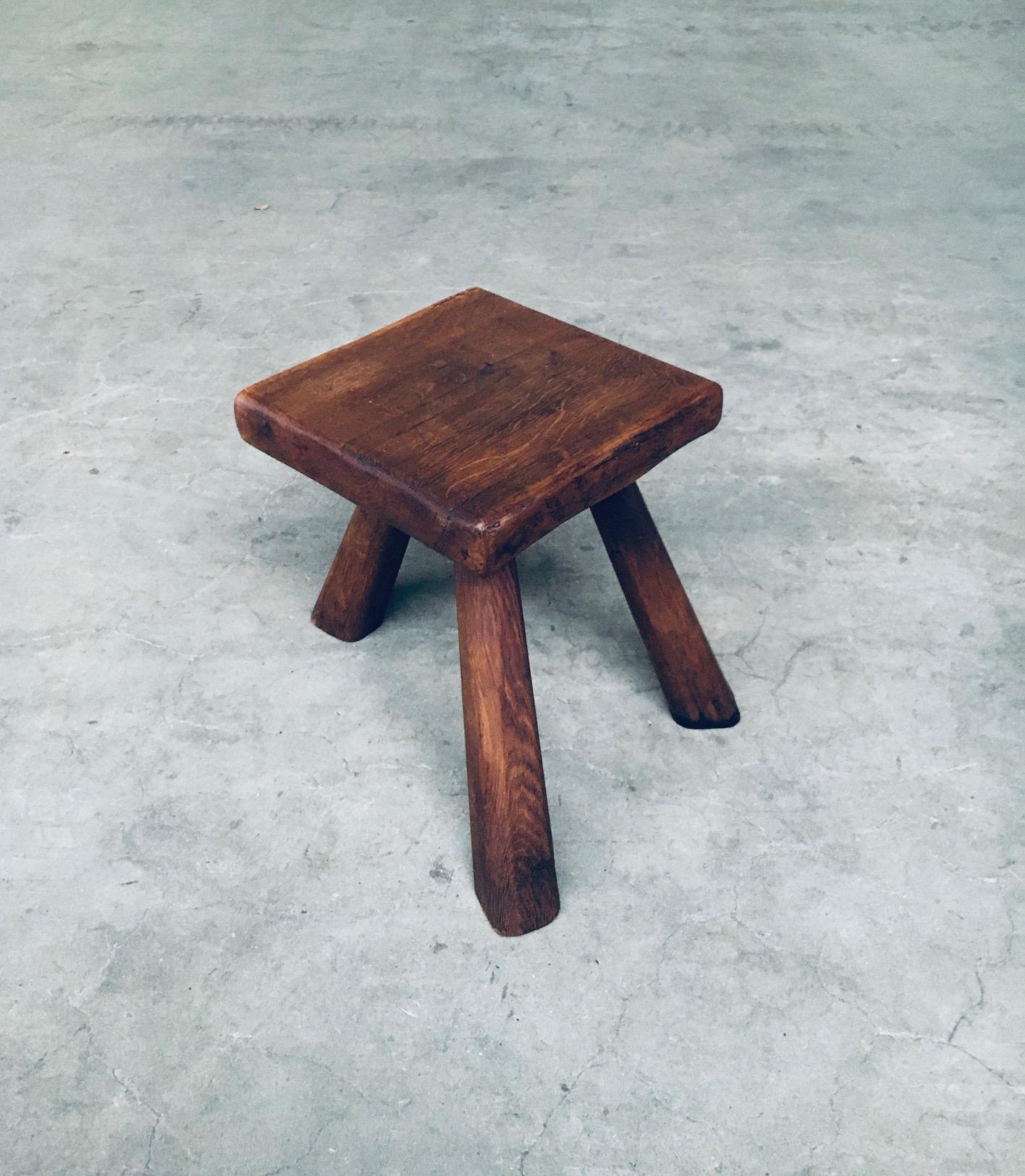 Vintage Tripod Oak Small Side Table / Stool. Made in Belgium, 1950's. Solid oak constructed handmade hand carved stool or side table. This comes in very good condition, with a nice darker patina. Measures 32cm x 39cm x 34cm.