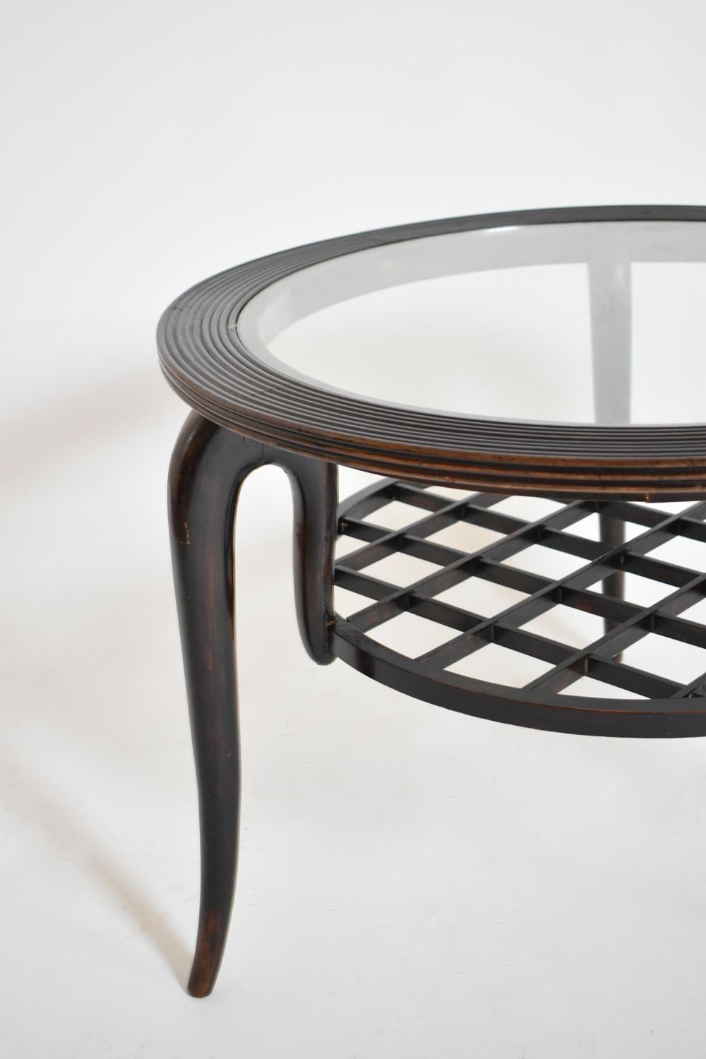 Tripod ebonised wooden round coffee table, side table. The table top made of glass, with a crosspiece tray under. In the style of Paolo Buffa Italy, 1940s.