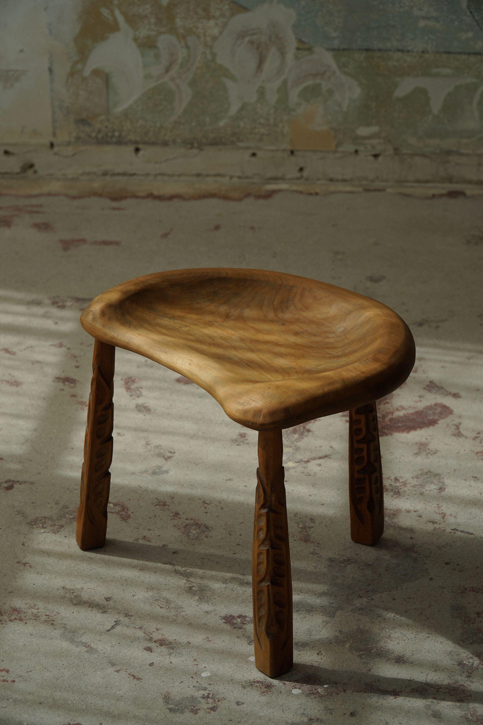 Beautiful patinated vintage tripod stool in solid oak. Made by an unknown Danish Cabinetmaker in 1950s. Finely hand carved legs and a comfortable seat. 

This modern stool will fit in many types of home decors. Classic, Wabi Sabi, Scandinavian or