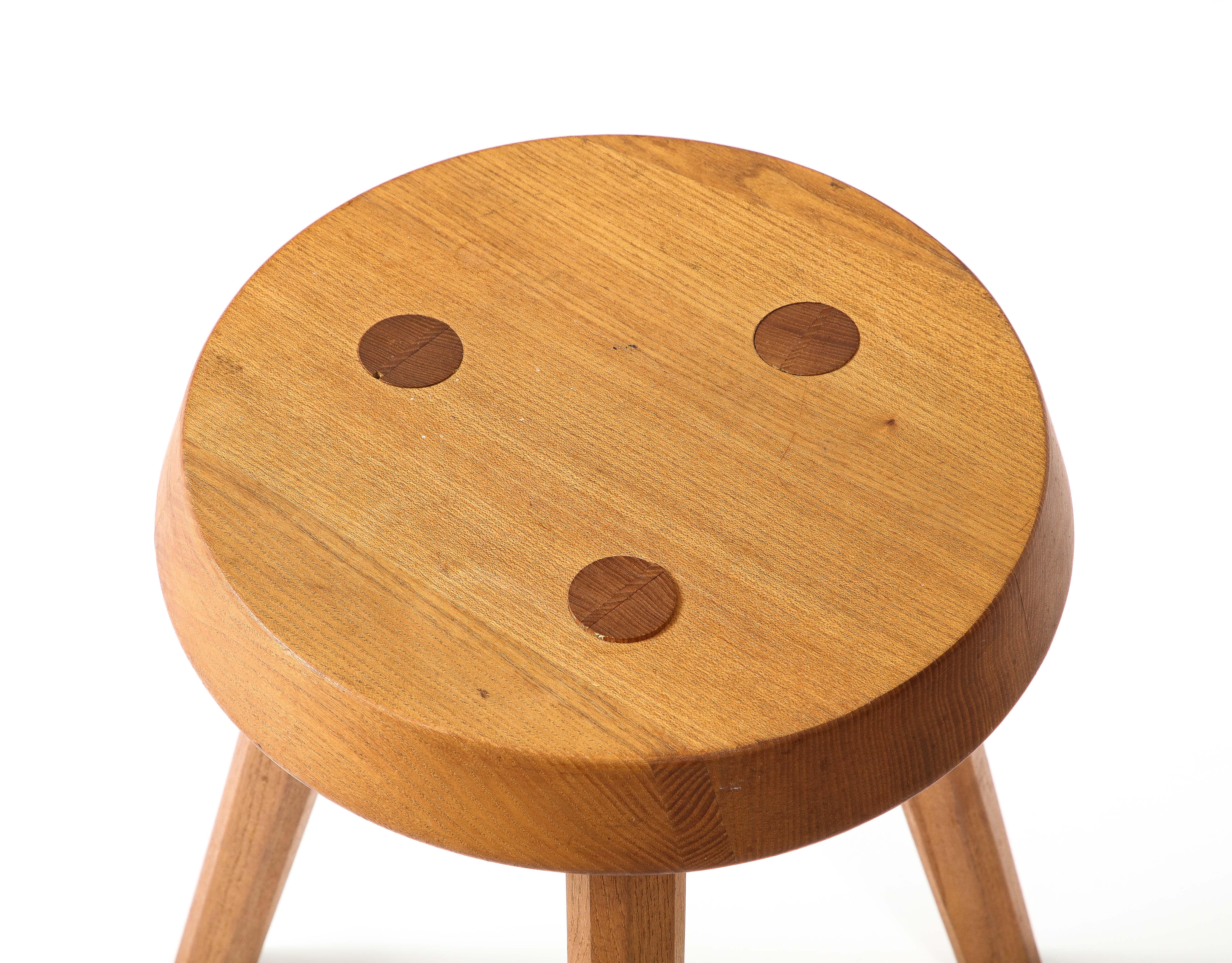 Oak tripod stool with visible dowels.
