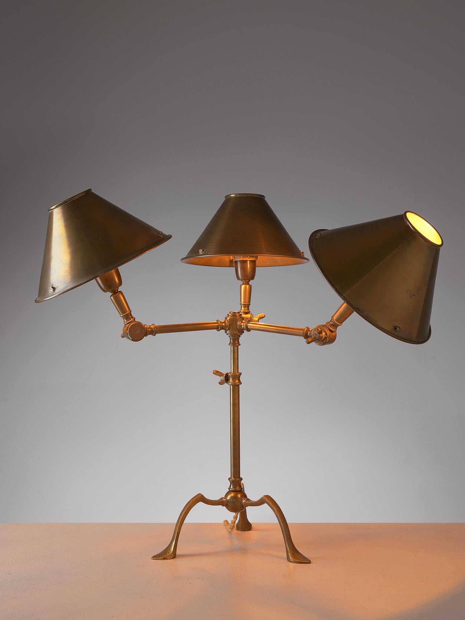 Table light, brass, Italy, 1960s

Playful desk light, completely executed in brass. The lamp features a tripod foot and three arms with the shade. The arms are adjustable in any direction, which results in a versatile and almost comical piece.

