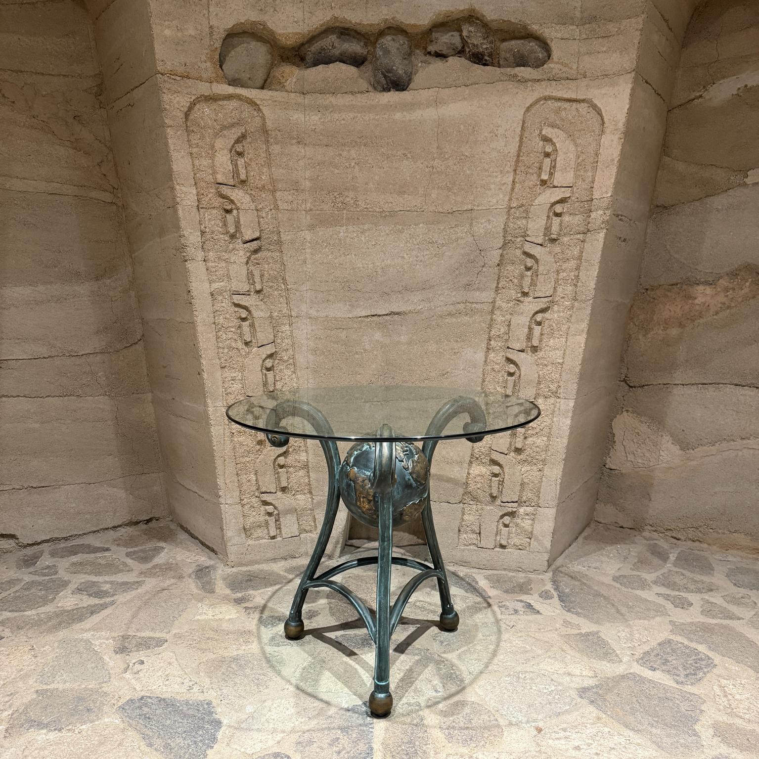For your consideration, an entry table made of bronze with the shape of a Globe with Tripod  legs a beveled Glass Top.  Patinated Bronze Base signed, unable to read foundry or artist name. 
Maker's stamp present.
29.5 h with glass
Glass .5 thick x