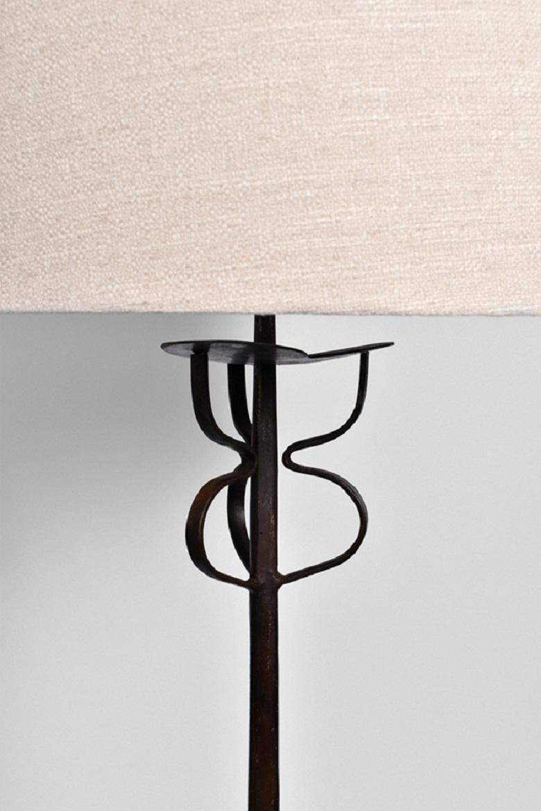 Tripod wrought iron floor lamp with a geometrical shape at the top. France, 1960s. 