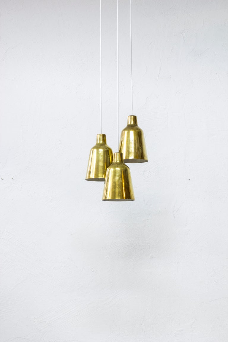 Ceiling lamp designed by Hans Bergström. Produced by Ateljé Lyktan in Åhus, Swede during the 1940s. Made from solid polished brass with perforated shades and original triple ceiling mount. Very good vintage condition with age related wear and