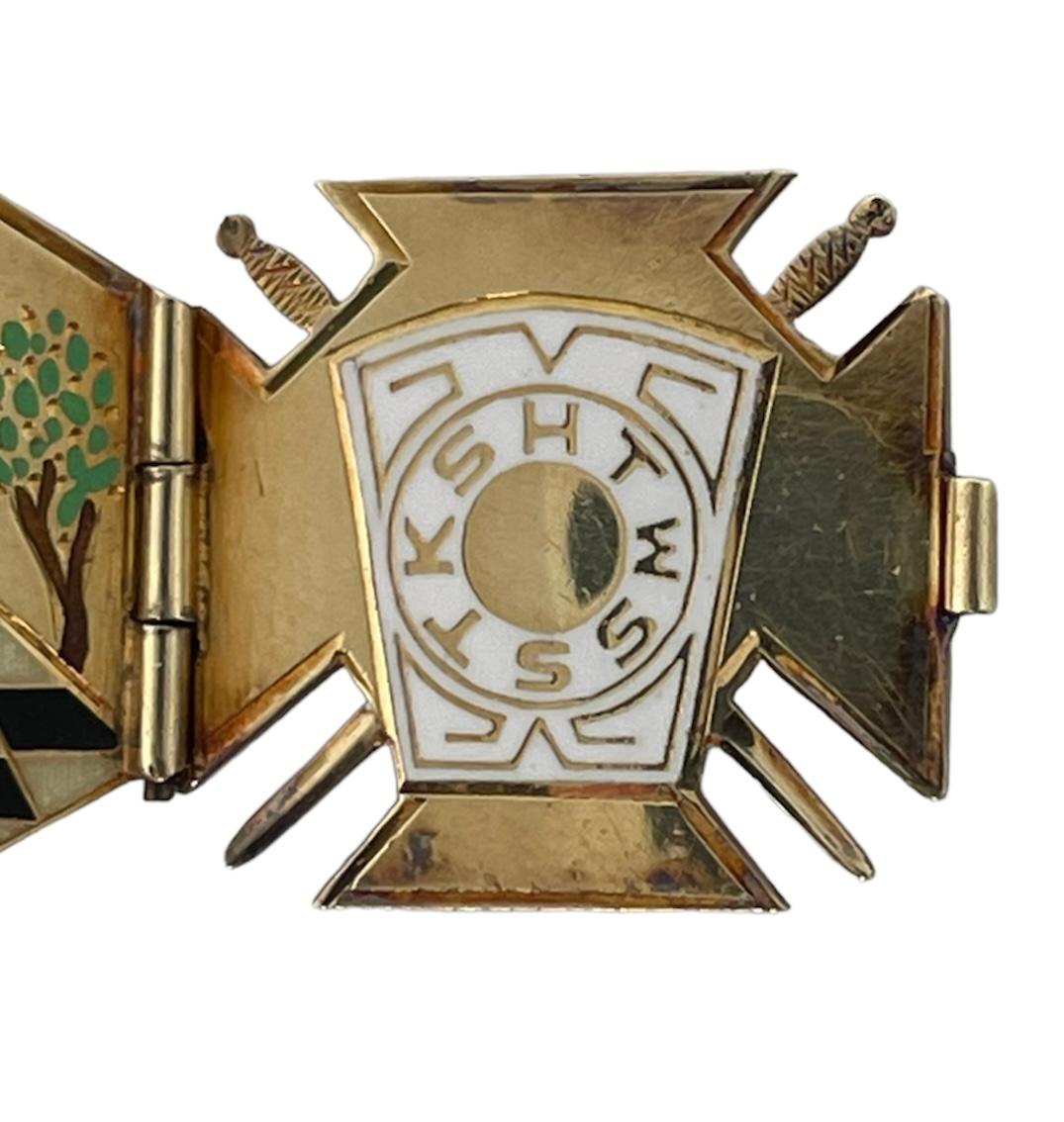 This is a 14K yellow gold and enameled Masonic 32nd degree Double Eagles pendant. The pendant open in the front and back to show a triptych. This triptych is shaped as a cross at the beginning and in the end, but in the middle is shaped as a