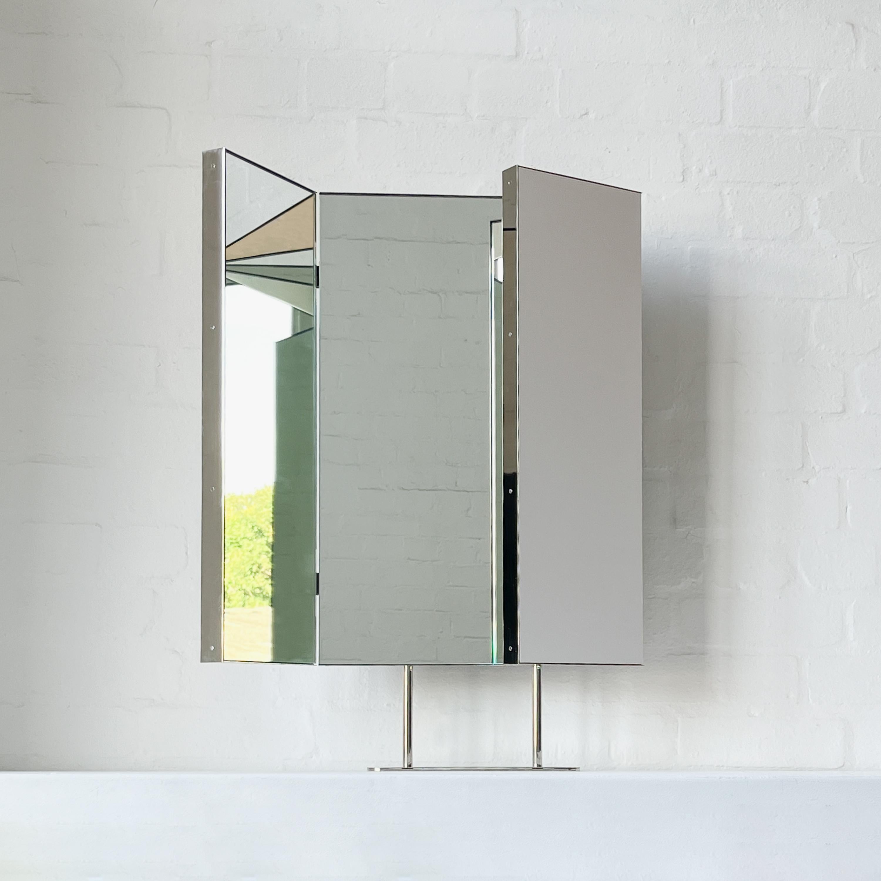 Contemporary triptych countertop rectangular mirror with an elegant nickel plated frame. Composed of three hinged rectangular panels, the side ones which have 180 degrees of adjustable angle. Designed and handcrafted in London, UK. This mirror is