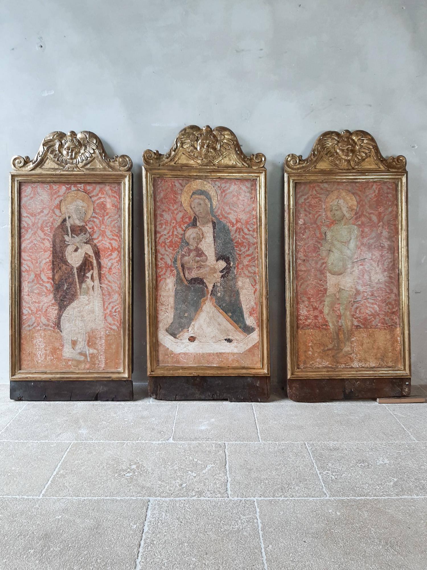 Triptych with fresco dating from the 14th to 15th century. Siena, Italy.

Three very old, special frescoes on walnut depicting the Madonna and Child (center), Saint Roch (left) and Saint Sebastian (right).

Hand-carved wooden frames of which the