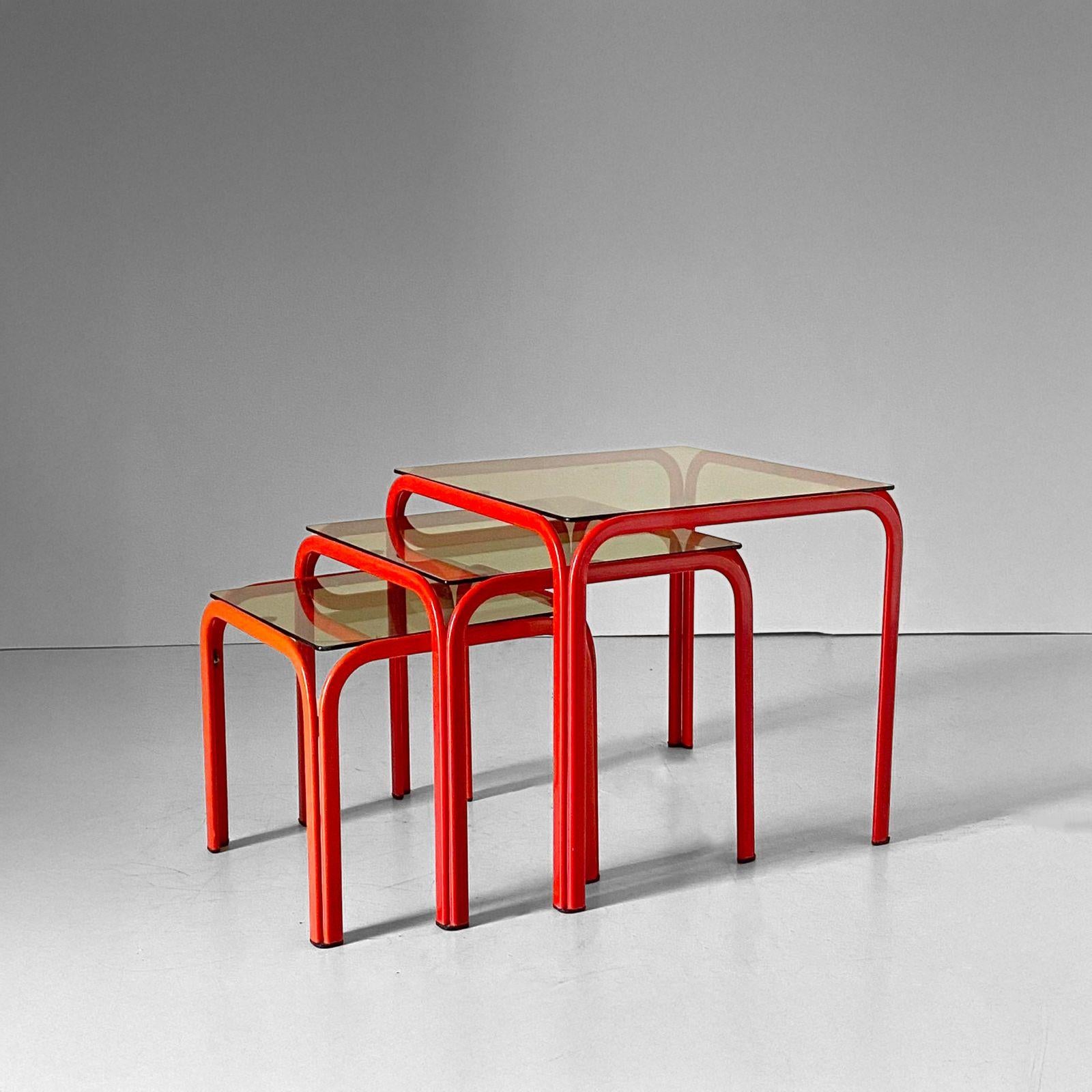 Vintage Nesting Tables with Red Iron Frame & Smoked Glass - Italy, 1970s

A striking set of vintage nesting tables from the 1970s, these pieces feature a bold red-colored iron frame paired with elegant smoked glass tops. Their clean lines and