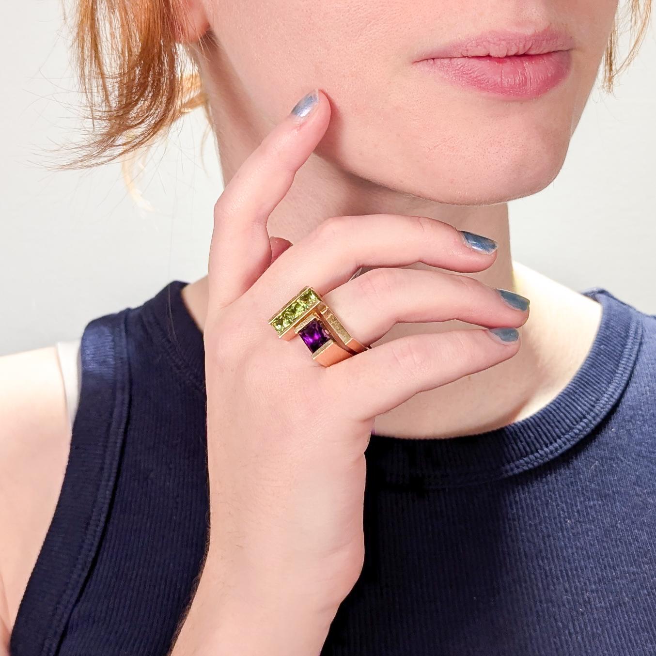 A very fine signed gold and tourmaline cocktail ring.

By Trisko. 

In 14k yellow gold. 

The ring square-shaped with an offset rectanglar head (set to the right side).

Channel set with three faceted, princess cut green tourmaline