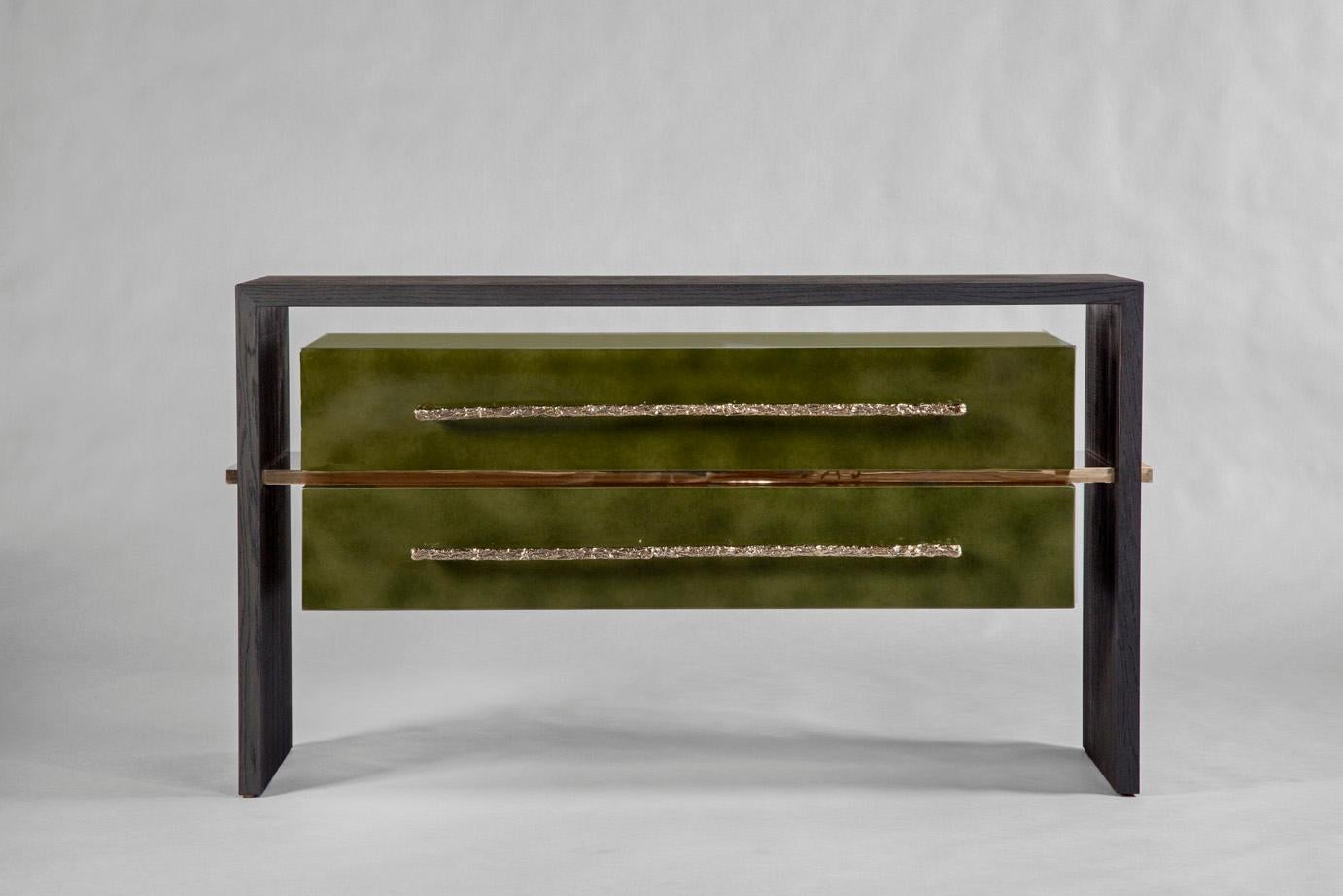 Sand-blasted oak in a matte bark finish. A central polished bronze stretcher holds the two-drawer cabinet finished in a dark green “Beka” lacquer with two long polished bronze handles.
The insides of the drawers are lined with felt. 
Custom sizes,