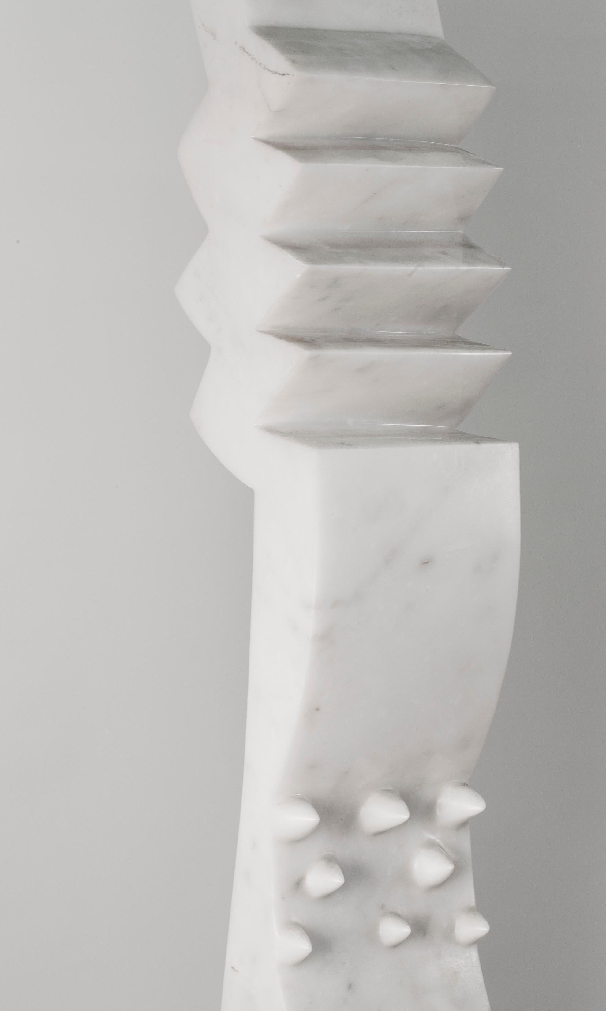 Born in Port-au-Prince, Haiti, but based in Italy, sculptor Tristian Cassamajor incorporates African themes into his remarkable, monumental marble and granite sculptures. This beautiful, knife-like composition in white marble is studded, bent and