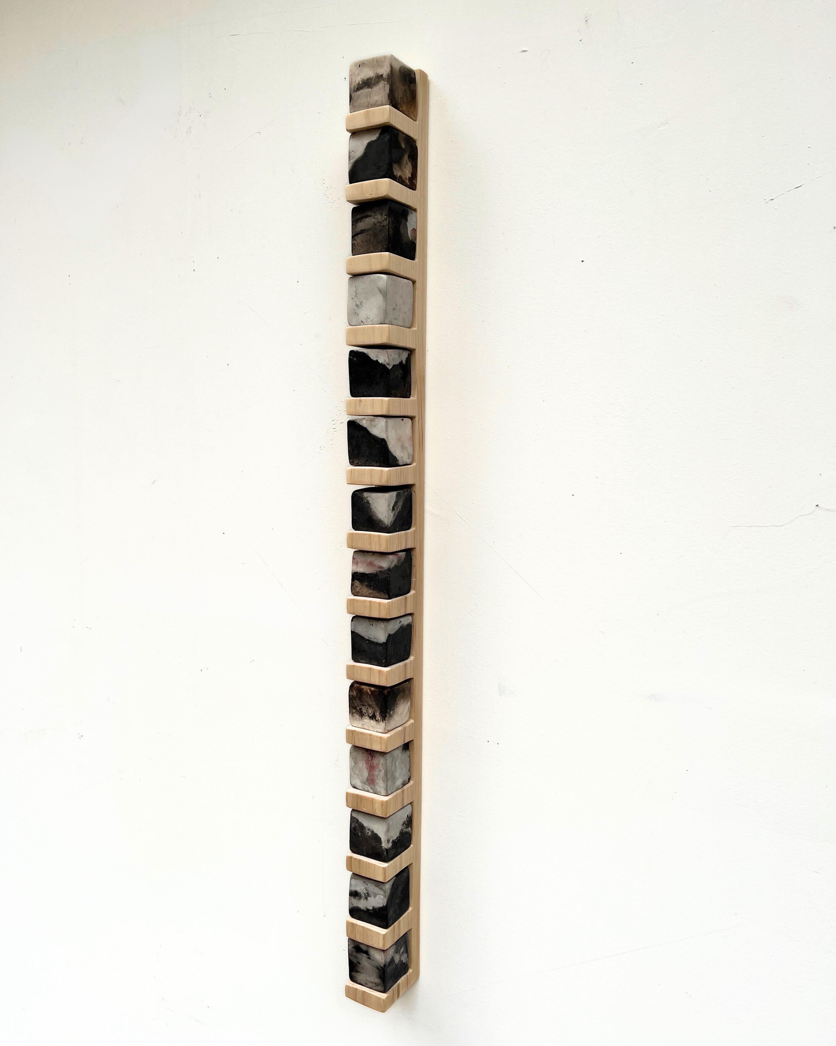 Contemporary wall-mounted sculpture by Tristan Fitch composed of pit-fired porcelain cubes on a hand-carved shelf made from locally sourced pine referencing architectural forms and alchemy. The porcelain cubes are first bisque fired in a kiln then