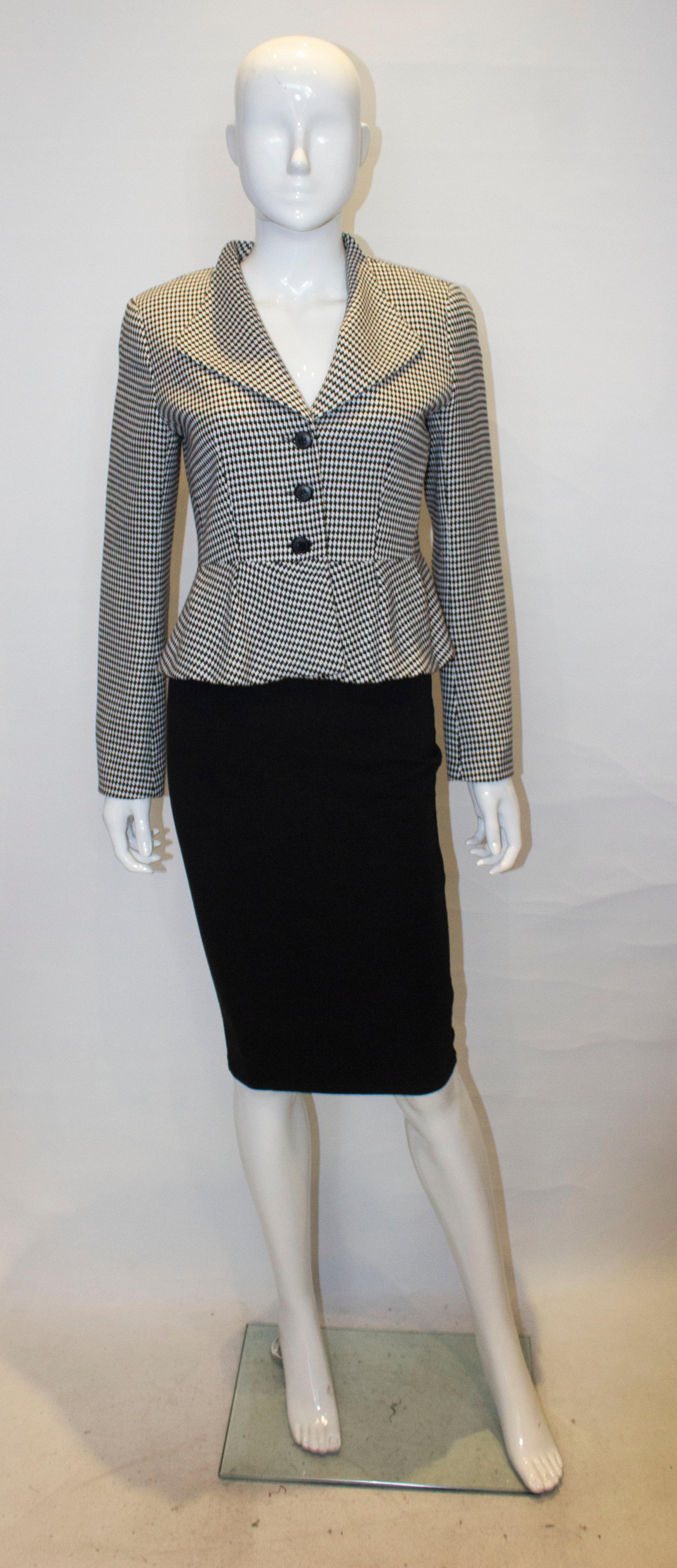 A nice fitted jacket by Tristar of Canada. The jacket is in a black and white fabric with interesting collar and three button opening.