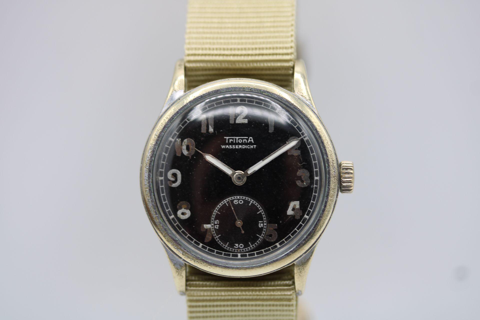 This Tritona Cal AS 1130, is likely a German military-issued watch. The AS 1130 refers to the A. Schild 1130 movement, a well-known Swiss mechanical movement used in many military and civilian watches from the mid-20th century.

These Tritona