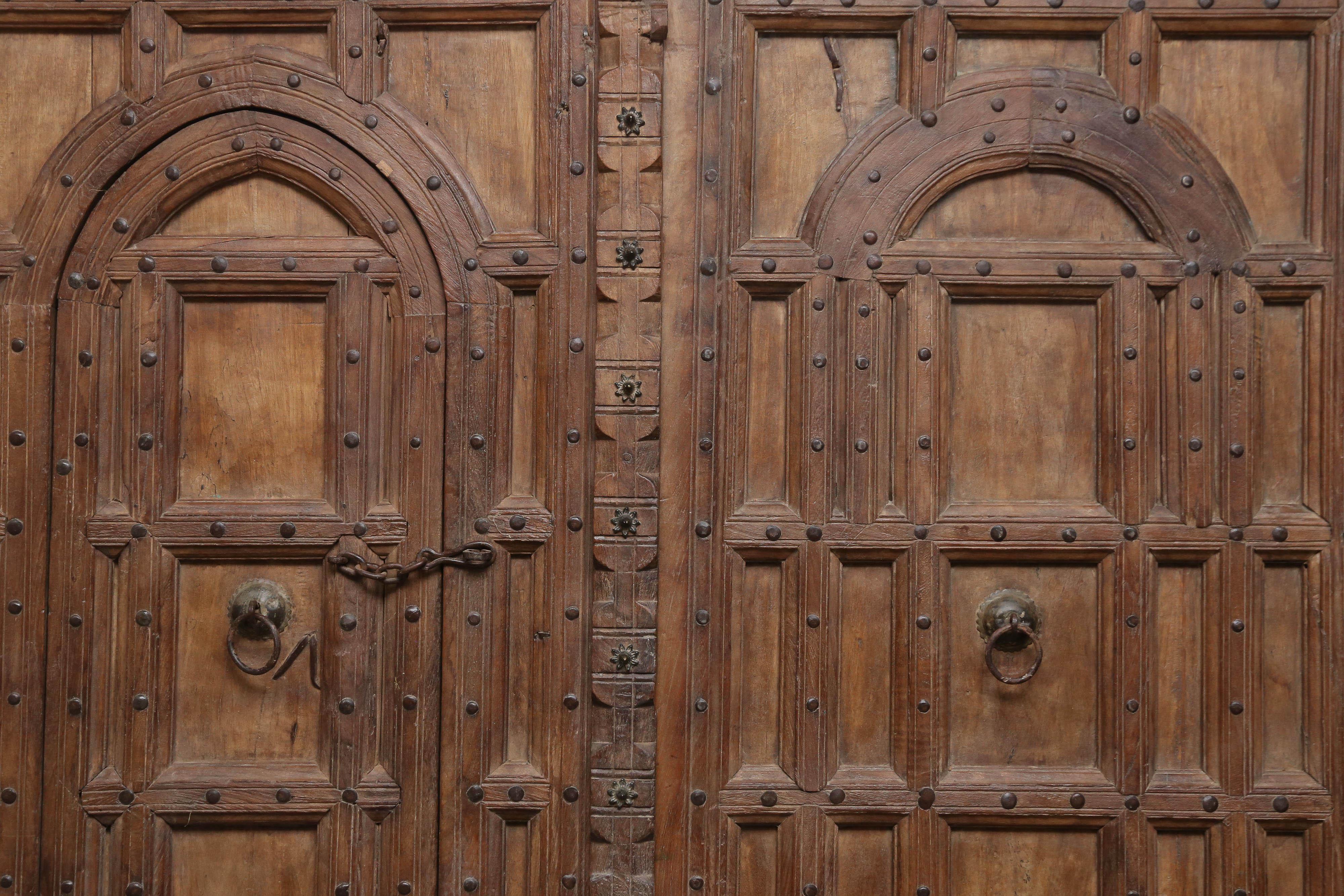 An extremely rare magnificent door from a fortified building in the north west frontier province in India. It was made in 1840's by using the finest teak wood available at that time. Fully hand crafted by handpicked artisans. It is a mixture of