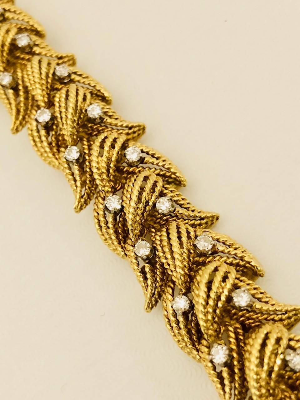 Fabulously crafted in 18 karat yellow gold, this bracelet features teardrop shape rope wire 'leaf' design.  Sprinkled throughout are prong set diamonds with tremendous sparkle.  Approximately 1.00 carat total weight.  G color VS clarity.  One 'leaf'