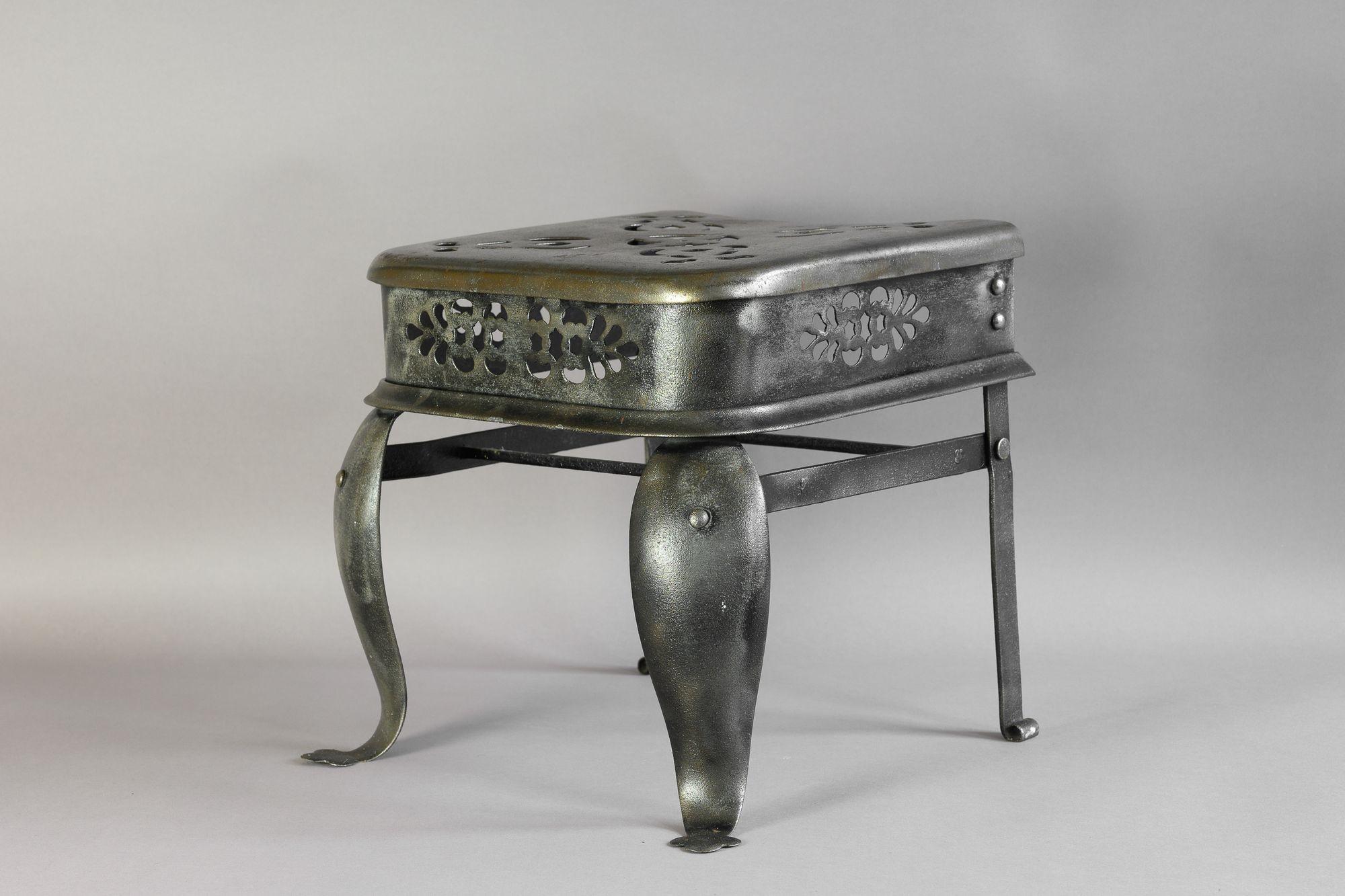 Steel trivet with pierced panel decoration. Circa 1830
H 33cm x W 36cm x D 36cm